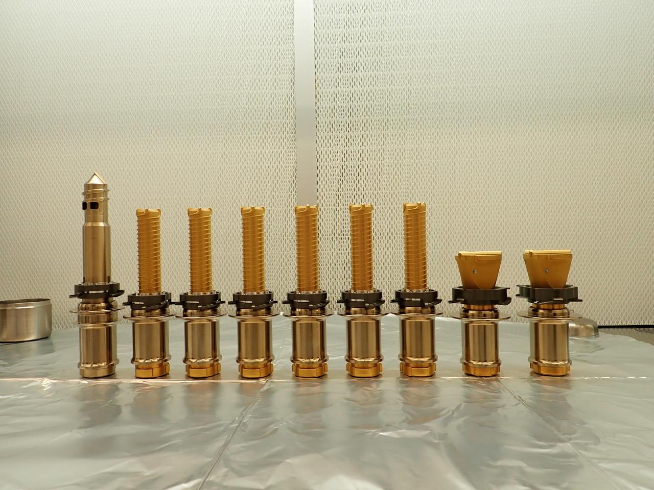 The drill bits used by NASA's Perseverance Mars rover are seen before being installed prior to launch. The regolith bit is on the left, followed by six bits used for drilling rock cores. On the right are two abrasion bits that are used to remove the dust-covered outer layer of a rock so that the rover can take accurate data of its composition. A key objective for Perseverance's mission on Mars is astrobiology, including the search for signs of ancient microbial life. The rover will characterize the planet's geology and past climate, pave the way for human exploration of the Red Planet, and be the first mission to collect and cache Martian rock and regolith (broken rock and dust). Subsequent NASA missions, in cooperation with ESA (European Space Agency), would send spacecraft to Mars to collect these sealed samples from the surface and return them to Earth for in-depth analysis. The Mars 2020 Perseverance mission is part of NASA's Moon to Mars exploration approach, which includes Artemis missions to the Moon that will help prepare for human exploration of the Red Planet. https://photojournal.jpl.nasa.gov/catalog/PIA25590