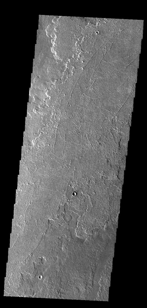 Today's VIS image shows a small portion of the immense lava flows that originated from Arsia Mons. Arsia Mons is the southernmost of the three large aligned volcanoes in the Tharsis region. Arsia Mons' last eruption was 10s of million years ago. The different surface textures are created by differences in the lava viscosity and cooling rates. The lobate margins of each flow can be traced back to the start of each flow — or to the point where they are covered by younger flows. Flows in Daedalia Planum can be as long as 180 km (111 miles). For comparison the longest Hawaiian lava flow is only 51 km (˜31 miles) long. The total area of Daedalia Planum is 2.9 million square km – more than four times the size of Texas. Orbit Number: 91603 Latitude: -23.5547 Longitude: 238.804 Instrument: VIS Captured: 2022-08-08 20:42 https://photojournal.jpl.nasa.gov/catalog/PIA25610