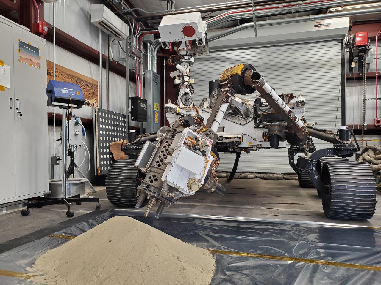 Optimism, a full-scale replica of NASA's Perseverance Mars rover, tests a model of Perseverance's regolith bit in a pile of simulated regolith – broken rock and dust – at the agency's Jet Propulsion Laboratory in Southern California. As with rock cores, Perseverance uses a drill on the end of its robotic arm to collect regolith samples. But to gather the loose material of Martian regolith the rover employs a different drill bit that looks like a spike with small holes on its end. A key objective for Perseverance's mission on Mars is astrobiology, including the search for signs of ancient microbial life. The rover will characterize the planet's geology and past climate, pave the way for human exploration of the Red Planet, and be the first mission to collect and cache Martian rock and regolith (broken rock and dust). Subsequent NASA missions, in cooperation with ESA (European Space Agency), would send spacecraft to Mars to collect these sealed samples from the surface and return them to Earth for in-depth analysis. The Mars 2020 Perseverance mission is part of NASA's Moon to Mars exploration approach, which includes Artemis missions to the Moon that will help prepare for human exploration of the Red Planet. https://photojournal.jpl.nasa.gov/catalog/PIA25651