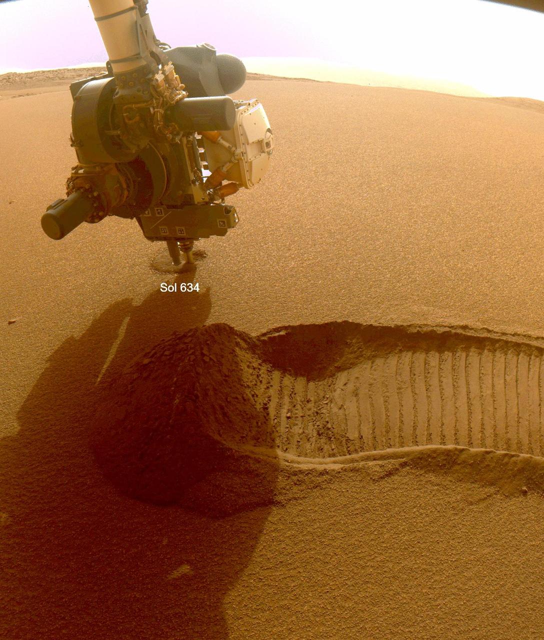 This GIF shows NASA's Perseverance Mars rover collecting two samples of regolith – broken rock and dust – with a regolith sampling bit on the end of its robotic arm. The samples were collected on Dec. 2 and 6, 2022, the 634th and 639th Martian days, or sols, of the mission. The images were taken by one of the rover's front hazard cameras.  One of the two regolith samples will be considered for deposit on the Martian surface in coming weeks as part of the Mars Sample Return campaign. Studying regolith with powerful lab equipment back on Earth will allow scientists to better understand the processes that have shaped the surface of Mars and help engineers design future missions as well as equipment used by future Martian astronauts.  A key objective for Perseverance's mission on Mars is astrobiology, including the search for signs of ancient microbial life. The rover will characterize the planet's geology and past climate, pave the way for human exploration of the Red Planet, and be the first mission to collect and cache Martian rock and regolith (broken rock and dust).  Subsequent NASA missions, in cooperation with ESA (European Space Agency), would send spacecraft to Mars to collect these sealed samples from the surface and return them to Earth for in-depth analysis.  The Mars 2020 Perseverance mission is part of NASA's Moon to Mars exploration approach, which includes Artemis missions to the Moon that will help prepare for human exploration of the Red Planet.  Movie available at https://photojournal.jpl.nasa.gov/catalog/PIA25654