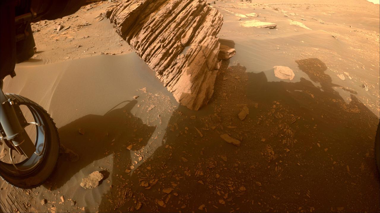 NASA's Perseverance Mars rover captured this image of "Bettys Rock" using one of its front hazard cameras on June 20, 2022, the 474th Martian day, or sol, of the mission.  The rock is named after Bettys Rock in Shenandoah National Park.  A key objective for Perseverance's mission on Mars is astrobiology, including the search for signs of ancient microbial life. The rover will characterize the planet's geology and past climate, pave the way for human exploration of the Red Planet, and be the first mission to collect and cache Martian rock and regolith (broken rock and dust).  Subsequent NASA missions, in cooperation with ESA (European Space Agency), would send spacecraft to Mars to collect these sealed samples from the surface and return them to Earth for in-depth analysis.  The Mars 2020 Perseverance mission is part of NASA's Moon to Mars exploration approach, which includes Artemis missions to the Moon that will help prepare for human exploration of the Red Planet.  https://photojournal.jpl.nasa.gov/catalog/PIA25655