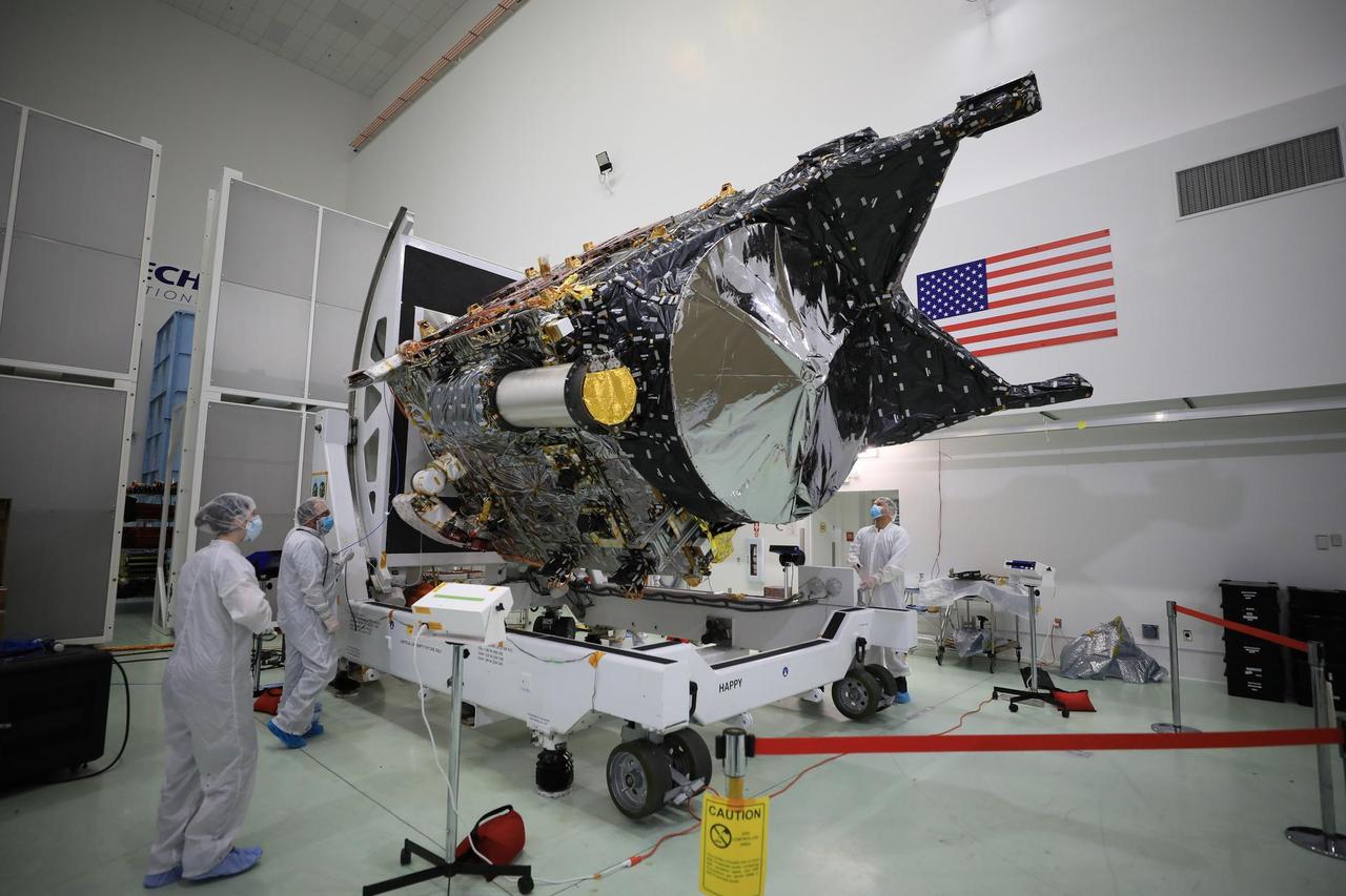 NASA's Psyche spacecraft is shown in a clean room on Dec. 8, 2022, at Astrotech Space Operations Facility near the agency's Kennedy Space Center in Florida. The spacecraft was powered on and connected to ground support equipment, enabling engineers and technicians to prepare it for launch in 2023. Teams working at Astrotech and at NASA's Jet Propulsion Laboratory in Southern California continue to monitor the health of its systems.  After a one-year delay to complete critical testing, the Psyche project is targeting an October 2023 launch on a SpaceX Falcon Heavy rocket. NASA's Deep Space Optical Communications (DSOC) technology demonstration, testing high-data-rate laser communications, is integrated into Psyche and will travel with it when it launches to its target, a metal-rich asteroid, also named Psyche, that lies in the main asteroid belt. The silver-colored cylinder shown in the photo is the sunshade for DSOC, and the gold blanketing is the aperture cover for the DSOC payload.  The spacecraft's target may be the partial core of a planetesimal, a building block of rocky planets in our solar system. Researchers will study Psyche using a suite of instruments including multispectral cameras, a Gamma Ray and Neutron Spectrometer (GRNS) and a magnetometer. The GRNS and magnetometer sensors are visible in the photo as the tips of the two black protrusions at the far end of the spacecraft. Also visible is the large, disc-shaped high-gain antenna, which will enable the spacecraft to communicate with Earth.  https://photojournal.jpl.nasa.gov/catalog/PIA25664