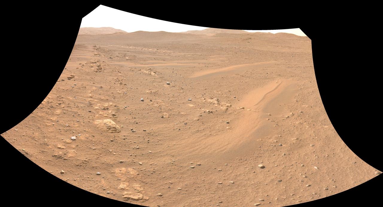 One of the Navcam imagers aboard NASA's Perseverance Mars rover captured the Ingenuity Mars Helicopter on Feb. 26, 2023, the 719th Martian day, or sol, of the mission. The helicopter is visible in the upper left of image. Ingenuity had landed there, at "Airfield Theta," on the previous sol at the conclusion of its 46th flight on Mars. At the time this enhanced image was taken, the helicopter was approximately 490 feet (150 meters) from the rover.  Figure A is the same enhanced image annotated to indicate the location of the Mars Helicopter in the distance.  A key objective for Perseverance's mission on Mars is astrobiology, including the search for signs of ancient microbial life. The rover will characterize the planet's geology and past climate, pave the way for human exploration of the Red Planet, and be the first mission to collect and cache Martian rock and regolith (broken rock and dust).  Subsequent NASA missions, in cooperation with ESA (European Space Agency), would send spacecraft to Mars to collect these sealed samples from the surface and return them to Earth for in-depth analysis.  The Mars 2020 Perseverance mission is part of NASA's Moon to Mars exploration approach, which includes Artemis missions to the Moon that will help prepare for human exploration of the Red Planet.NASA's Jet Propulsion Laboratory, which is managed for the agency by Caltech in Pasadena, California, built and manages operations of the Perseverance rover.  https://photojournal.jpl.nasa.gov/catalog/PIA25685