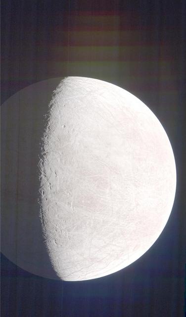 NASA's Juno mission captured this view of Jupiter's intriguing, icy moon Europa during a close pass on Sept. 29, 2022. The contrast has been enhanced to help scientists look for signs of eruptions along the limb and terminator – the dividing line between the day and night sides of the moon. None were identified. When processed this way, the image shows features on Europa's night side illuminated by sunlight reflected from Jupiter, also called Jupiter shine. Along the terminator, low-angle sunlight highlights topography on the moon's surface.  At the time the image was taken, the Juno spacecraft was 945 miles (1,521 kilometers) from Europa.  Citizen scientist Brian Swift processed the image from raw data from the spacecraft's JunoCam public engagement camera, brightening darker regions and enhancing the contrast.  https://photojournal.jpl.nasa.gov/catalog/PIA25694
