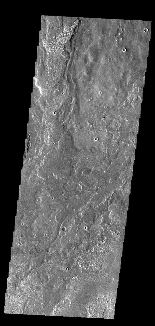 Today's VIS image shows a small portion of the immense lava flows that originated from Arsia Mons. Arsia Mons is the southernmost of the three large aligned volcanoes in the Tharsis region. Arsia Mons' last eruption was 10s of million years ago. The different surface textures are created by differences in the lava viscosity and cooling rates. The lobate margins of each flow can be traced back to the start of each flow — or to the point where they are covered by younger flows. Flows in Daedalia Planum can be as long as 180 km (111 miles). For comparison the longest Hawaiian lava flow is only 51 km (˜31 miles) long. The total area of Daedalia Planum is 2.9 million square km – more than four times the size of Texas. Orbit Number: 92152 Latitude: -22.9243 Longitude: 240.536 Instrument: VIS Captured: 2022-09-23 01:36 https://photojournal.jpl.nasa.gov/catalog/PIA25748