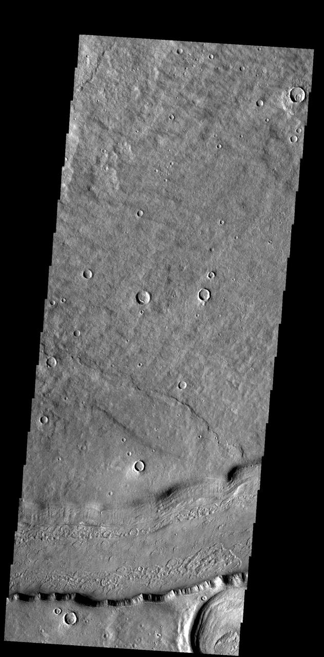 This VIS image shows a short section of Reull Vallis. Reull Vallis starts in Promethei Terra and empties into Hellas Plainitia. Reull Vallis is 1051km (653 miles) long. Orbit Number: 92169 Latitude: -41.0221 Longitude: 107.284 Instrument: VIS Captured: 2022-09-24 11:18 https://photojournal.jpl.nasa.gov/catalog/PIA25750