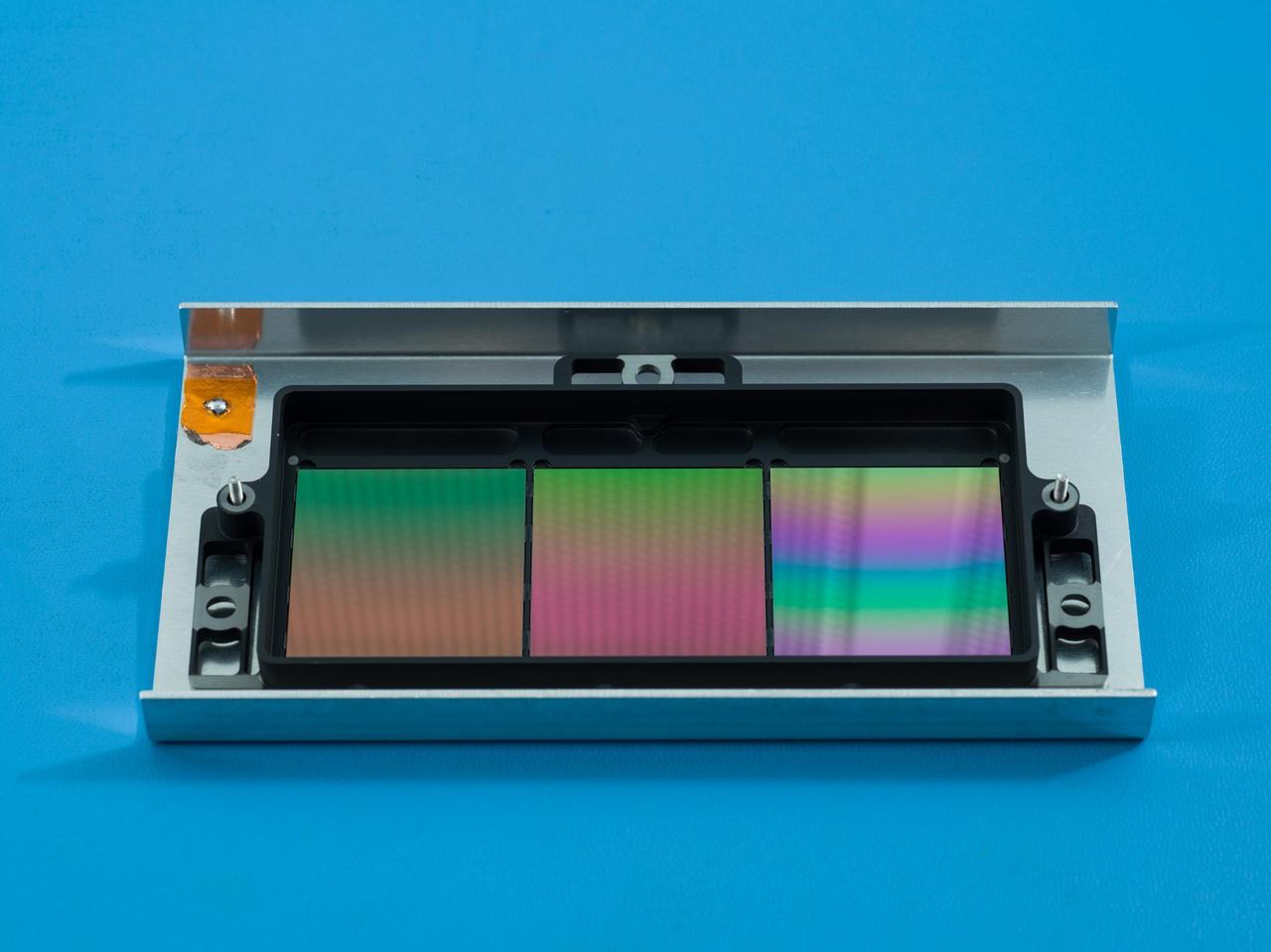 NASA's SPHEREx mission will use these filters to conduct spectroscopy, a technique that lets scientists measure individual wavelengths of light from a source, which can reveal information such as the chemical composition of the object or how far away it is.  Each about the size of a cracker, the filters appear iridescent to the naked eye. The filters have multiple segments that block all but one specific wavelength of infrared light. Every object SPHEREx images will be observed by each segment, enabling scientists to see the specific infrared wavelengths emitted by every star or galaxy the telescope views. In total, SPHEREx can observe more than 100 distinct wavelengths.  Short for Specto-Photometer for the History of the Universe, Epoch of Reionization and Ices Explorer, SPHEREx will create a map of the cosmos like no other, imaging the entire sky and gathering information about millions of galaxies. With this map, scientists will study what happened in the first fraction of a second after the big bang, the history of galaxy evolution, and the origins of water in planetary systems in our galaxy.  https://photojournal.jpl.nasa.gov/catalog/PIA25788