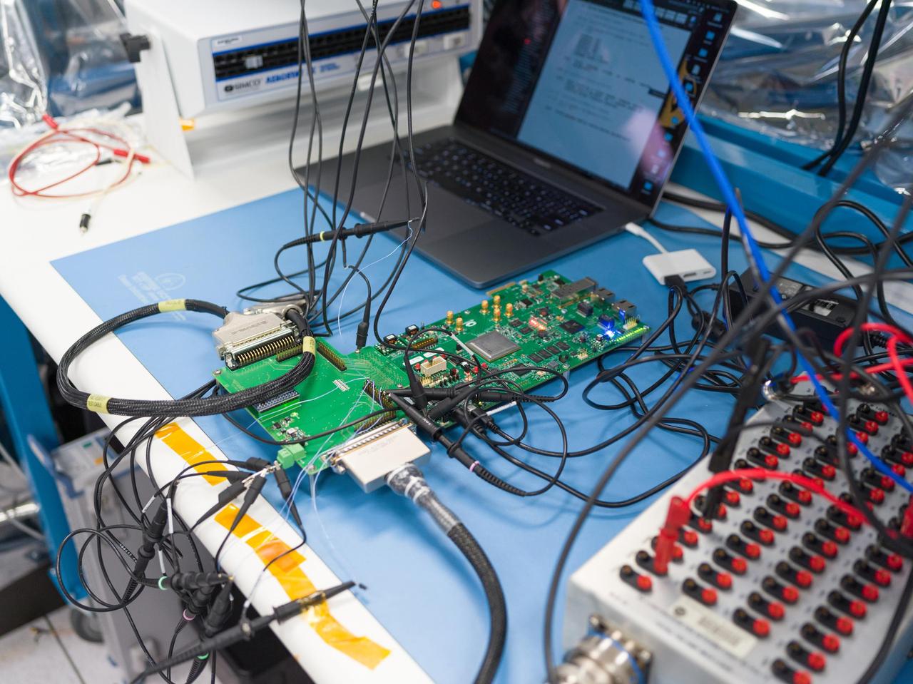 Seen here in March 2023, prototype hardware for the Venus Interferometric Synthetic Aperture Radar (VISAR) underwent interface testing at NASA's Jet Propulsion Laboratory in Southern California. VISAR is being developed at JPL for NASA's Venus Emissivity Radio Science, InSAR, Topography & Spectroscopy (VERITAS) mission that will launch within a decade to explore Earth's twin. These early interface tests are the first in a series to be run by JPL and Thales Alenia Space Italy (TASI), an international partner of the VERITAS mission that is contributing hardware to the instrument.  Figure A shows TASI engineers Luca Di Marco Napini and Gabriel Mihu working in a JPL cleanroom on the VISAR prototype hardware.  When VERITAS arrives in orbit, it will use VISAR to create detailed 3D global maps of Venus. The spacecraft will also carry a near-infrared spectrometer to figure out what the surface is made of. Together, the instruments will offer clues about the planet's past and present geologic processes, help reveal how the paths of Venus and Earth diverged, and how Venus lost its potential as a habitable world. VERITAS is managed by JPL.  VERITAS and NASA's Deep Atmosphere Venus Investigation of Noble gases, Chemistry, and Imaging (DAVINCI) mission were selected in 2021 under NASA's Discovery Program as the agency's next missions to Venus. The Discovery Program is managed by the Planetary Missions Program Office at NASA's Marshall Space Flight Center in Huntsville, Alabama, for the Planetary Science Division of NASA's Science Mission Directorate in Washington.  https://photojournal.jpl.nasa.gov/catalog/PIA25832
