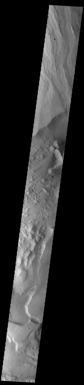 Today's VIS image shows a small portion of both Dao Vallis (middle of image) and Niger Vallis (bottom of image). Arising from the volcano Hadriacus Mons (top of image), Dao Vallis is approximately 1200km (750 miles) long. Niger Vallis is 333 km (207 miles) long. It has been proposed that heating of the region due to volcanic activity melted subsurface ice which was released to the surface to carve the two channels. Niger Vallis merges with Dao Vallis south of this image and then flow southwestward into the Hellas Planitia basin.  Orbit Number: 93355 Latitude: -33.4749 Longitude: 93.0394 Instrument: VIS Captured: 2022-12-31 02:58  https://photojournal.jpl.nasa.gov/catalog/PIA25852