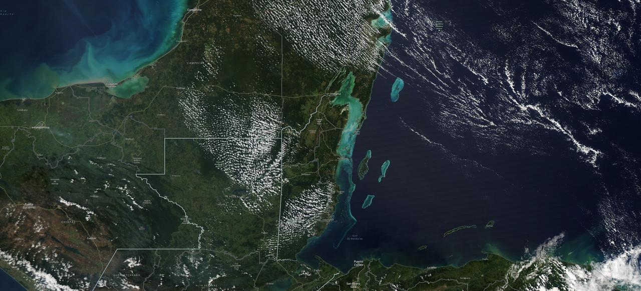 The Moderate Resolution Imaging Spectroradiometer (MODIS) instrument aboard NASA's Aqua satellite captured this image of the Yucatán Peninsula on Feb. 3, 2022. At the center is Belize, a country whose Caribbean coast is home to the Belize Barrier Reef Reserve System, which encompasses a vibrant network of marine environments that supports thousands of animal and plant species and drives Belize's largest industry, tourism. The barrier reef system is among about 1,200 UNESCO World Heritage sites around the world.  In a paper published in November 2022 in Frontiers in Remote Sensing, researchers used data from Aqua MODIS to rank 24 protected marine areas off the Belizean coast based on the risks coral face from murky water and rising temperatures. The research also outlined how researchers at NASA's Jet Propulsion Laboratory in Southern California and counterparts in Belize used free, cloud-based data on Google Earth Engine in their analysis.  Analyzing imagery from 2002 to 2022, researchers developed a coral vulnerability index – a score between 2 and 12 that characterizes the risk to coral, with higher scores signifying greater risk. Their findings could help management authorities protect the reefs from human impacts such as development, overfishing, pollution, and climate change.  https://photojournal.jpl.nasa.gov/catalog/PIA25861