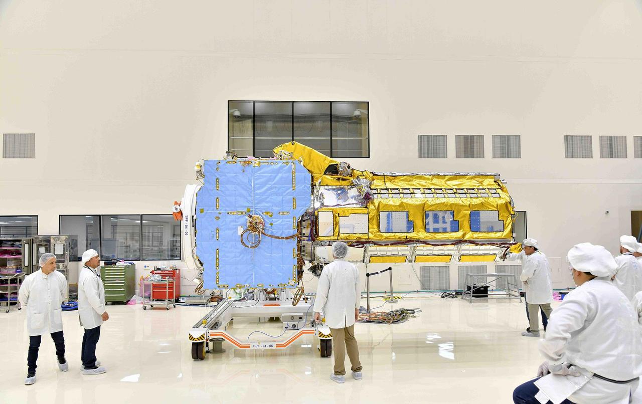 The NISAR (NASA-ISRO Synthetic Aperture Radar) satellite sits in a clean room facility at U R Rao Satellite Centre (URSC) in Bengaluru, India, in mid-June 2023, shortly after engineers from NASA's Jet Propulsion Laboratory in Southern California and the Indian Space Research Organisation joined its two main components, the radar instrument payload and the spacecraft bus. Set to launch in early 2024 from the Satish Dhawan Space Centre in Sriharikota, India, NISAR is being jointly developed by NASA and ISRO to observe movements of Earth's land and ice surfaces in extremely fine detail. As NISAR observes nearly every part of Earth at least once every 12 days, the satellite will help scientists understand, among other observables, the dynamics of forests, wetlands, and agricultural lands. The radar instrument payload, partially wrapped in gold-colored thermal blanketing, arrived from JPL in March and consists of L- and S-band radar systems, so named to indicate the wavelengths of their signals. Both sensors can see through clouds and collect data day and night. The bus, which is shown in blue blanketing and includes components and systems developed by both ISRO and JPL, was built at URSC and will provide power, navigation, pointing control, and communications for the mission. NISAR is an equal collaboration between NASA and ISRO and marks the first time the two agencies have cooperated on hardware development for an Earth-observing mission. JPL, which is managed for NASA by Caltech in Pasadena, leads the U.S. component of the project and is providing the mission's L-band SAR. NASA is also providing the radar reflector antenna, the deployable boom, a high-rate communication subsystem for science data, GPS receivers, a solid-state recorder, and payload data subsystem. URSC, which is leading the ISRO component of the mission, is providing the spacecraft bus, the S-band SAR electronics, the launch vehicle, and associated launch services and satellite mission operations. https://photojournal.jpl.nasa.gov/catalog/PIA25865