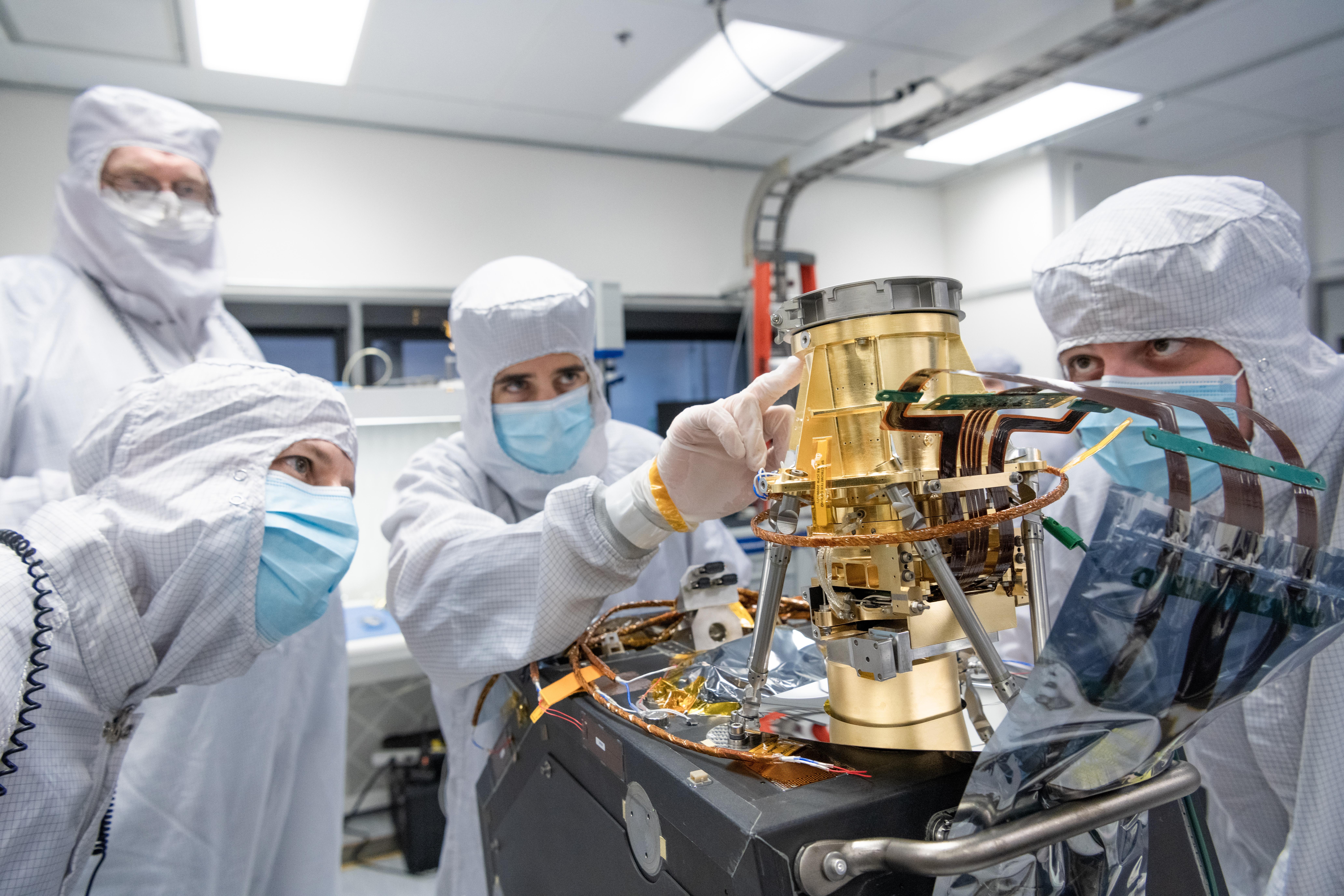       Engineers in a clean room at NASA's Jet Propulsion Laboratory in Southern California in April 2023 examine the imaging spectrometer that will ride aboard the first of two satellites to be launched by the Carbon Mapper Coalition. The instrument will help researchers detect emissions of carbon dioxide and methane from sources on Earth's surface from space.      The gold-colored component is the spectrometer, which was developed at JPL. It's designed to receive sunlight reflected from Earth and divide that light into hundreds of distinct colors in the near-infrared and visible portion of the electromagnetic spectrum. By analyzing the light's spectroscopic signature – the wavelengths that show up in the signal as well as those that do not – researchers can determine whether the instrument is observing greenhouse gas emissions and, if so, estimate their concentrations.      The black portion at the base of the instrument is a telescope that captures light from Earth's surface and reflects it into the spectrometer.      When released into the atmosphere, carbon dioxide and methane are the greenhouse gases most responsible for human-caused global warming. Both have unique spectral signatures that make them detectable from space via spectroscopy.      The imaging spectrometer is JPL's contribution to the Carbon Mapper Coalition, a joint effort led by the nonprofit Carbon Mapper that also includes Planet Labs PBC, the California Air Resources Board, Arizona State University, and the University of Arizona. Once the instrument is in orbit, researchers will use its measurements to identify the sources of carbon dioxide and methane plumes it detects. Identification of the origins of emissions is considered the first step towards mitigation.  https://photojournal.jpl.nasa.gov/catalog/PIA25869