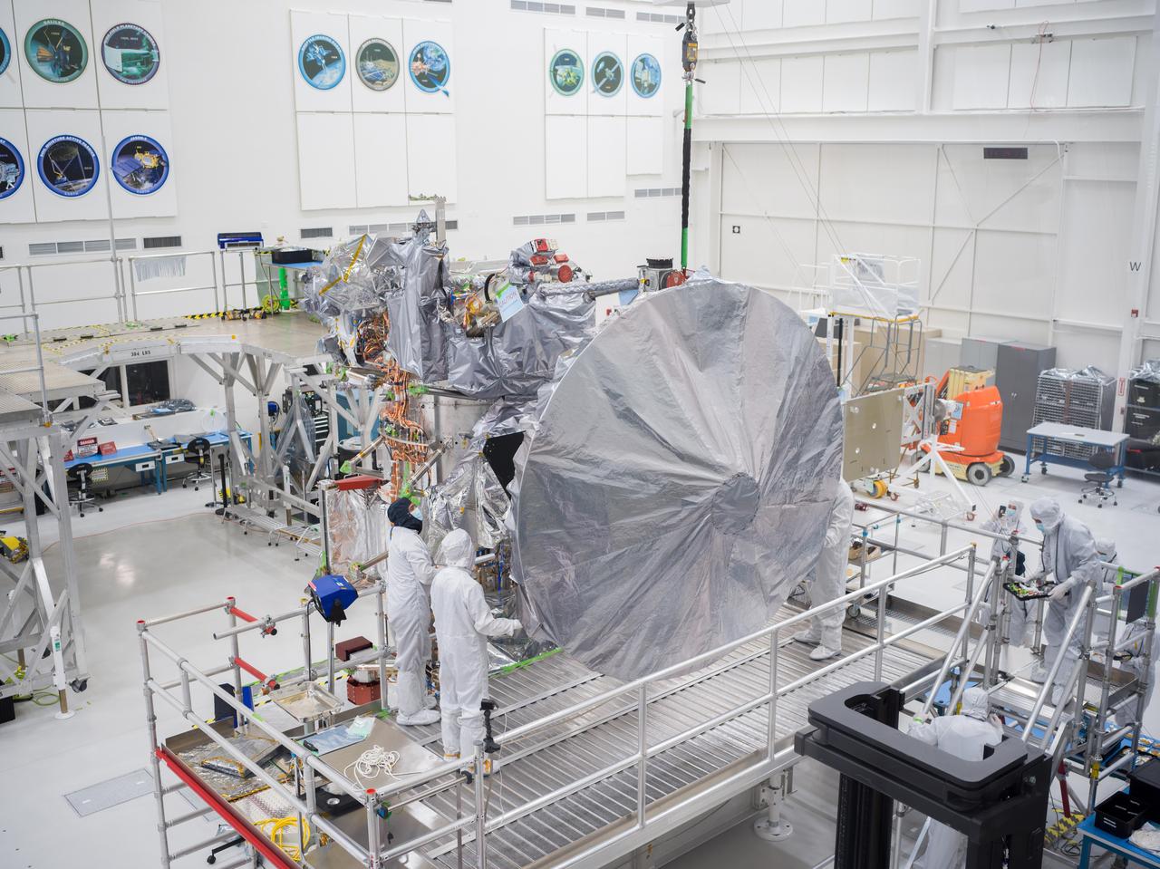 Engineers and technicians install a 10-foot (3-meter) high-gain antenna on NASA's Europa Clipper spacecraft on Aug. 14, 2023. The orbiter is being assembled in the clean room of the High Bay 1 clean room of the Spacecraft Assembly Facility at the agency's Jet Propulsion Laboratory, in preparation for launch to Jupiter's moon Europa in October 2024. The precision-engineered dish was attached to the spacecraft in carefully choreographed stages over the course of several hours.  Europa Clipper will need the huge antenna to transmit data hundreds of millions of miles back to Earth. Scientists believe the icy moon Europa harbors a vast internal ocean that may have conditions suitable for supporting life. The spacecraft will fly by the moon about 50 times while its science instruments gather data on the moon's atmosphere, surface, and interior – information that will help scientists learn more about the ocean, the ice crust, and potential plumes that may be venting subsurface water into space.   https://photojournal.jpl.nasa.gov/catalog/PIA25957