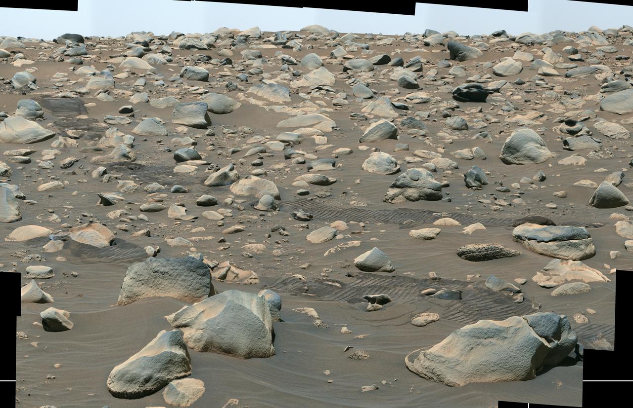 This composite image captured by NASA's Perseverance Mars rover shows boulders that decorate the top of the Jezero Crater fan deposit. Rover tracks across the middle of the image give a sense of scale. These boulders were transported by water that was either deeper or flowed faster than the ancient waterway that deposited the smaller pebbles that also populate the area. Because these boulders are sitting on top of the pebbles, scientists believe they arrived later, possibly much later.  Perseverance's Mastcam-Z camera system took the series of images that make up this composite on July 6, 2023, the 845th day, or sol, of the rover's mission to Mars.  Arizona State University leads the operations of the Mastcam-Z instrument, working in collaboration with Malin Space Science Systems in San Diego, on the design, fabrication, testing, and operation of the cameras, and in collaboration with the Niels Bohr Institute of the University of Copenhagen on the design, fabrication, and testing of the calibration targets.  A key objective for Perseverance's mission on Mars is astrobiology, including the search for signs of ancient microbial life. The rover will characterize the planet's geology and past climate, pave the way for human exploration of the Red Planet, and be the first mission to collect and cache Martian rock and regolith (broken rock and dust).  Subsequent NASA missions, in cooperation with ESA (European Space Agency), would send spacecraft to Mars to collect these sealed samples from the surface and return them to Earth for in-depth analysis.  The Mars 2020 Perseverance mission is part of NASA's Moon to Mars exploration approach, which includes Artemis missions to the Moon that will help prepare for human exploration of the Red Planet.  https://photojournal.jpl.nasa.gov/catalog/PIA25963