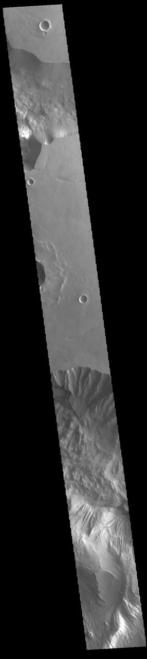 Today's VIS image shows part of two chasmatas – Hebes Chasma at the top of the image and Ophir Chasma at the bottom. Both chasmata have large landslide deposits. Ophir Chasma has a large layered deposit, which has subsequently been eroded by wind and fluvial processes (bottom of image). Hebes Chasma is an inclosed basin not connected to Valles Marineris. It is 319 km long (east/west, 198 miles), 130 km wide (north/south, 81miles) and up to 8km (5 miles) deep. Ophir Chasma is approximately 317km long (197 miles) and is part of the Valles Marineris system of canyons. Orbit Number: 94365 Latitude: -2.67943 Longitude: 286.449 Instrument: VIS Captured: 2023-03-24 07:37 https://photojournal.jpl.nasa.gov/catalog/PIA26005