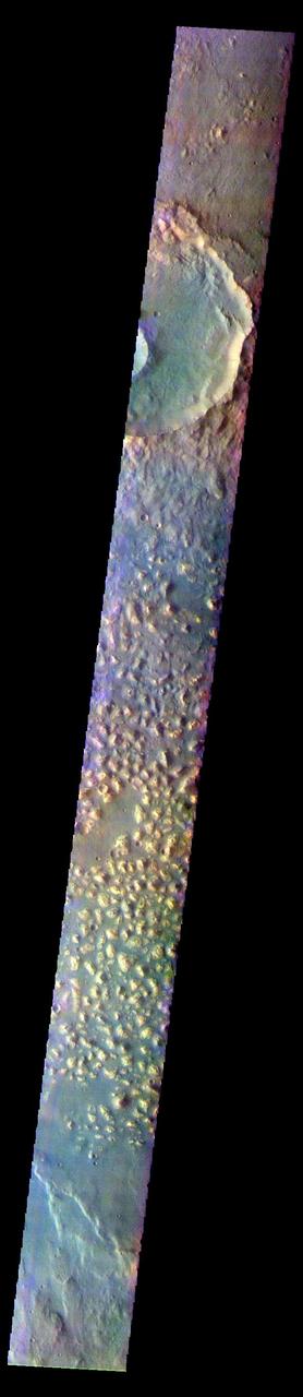 The THEMIS VIS camera contains 5 filters. The data from different filters can be combined in multiple ways to create a false color image. These false color images may reveal subtle variations of the surface not easily identified in a single band image. Today's false color image shows part of Ariadnes Colles. The term colles means hills or knobs. In this false color combination the hills stand out against the darker surrounding plains. This difference is due to the amount of dust covering the hills versus the plains.  The THEMIS VIS camera is capable of capturing color images of the Martian surface using five different color filters. In this mode of operation, the spatial resolution and coverage of the image must be reduced to accommodate the additional data volume produced from using multiple filters. To make a color image, three of the five filter images (each in grayscale) are selected. Each is contrast enhanced and then converted to a red, green, or blue intensity image. These three images are then combined to produce a full color, single image. Because the THEMIS color filters don't span the full range of colors seen by the human eye, a color THEMIS image does not represent true color. Also, because each single-filter image is contrast enhanced before inclusion in the three-color image, the apparent color variation of the scene is exaggerated. Nevertheless, the color variation that does appear is representative of some change in color, however subtle, in the actual scene. Note that the long edges of THEMIS color images typically contain color artifacts that do not represent surface variation.  Orbit Number: 92641 Latitude: -34.2832 Longitude: 171.529 Instrument: VIS Captured: 2022-11-02 07:59  https://photojournal.jpl.nasa.gov/catalog/PIA26090