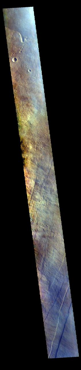 The THEMIS VIS camera contains 5 filters. The data from different filters can be combined in multiple ways to create a false color image. These false color images may reveal subtle variations of the surface not easily identified in a single band image. Today's false color image shows part of the flank of Arsia Mons. The three large aligned Tharsis volcanoes are Arsia Mons, Pavonis Mons and Ascreaus Mons (from south to north). There are collapse features on all three volcanoes, on the southwestern and northeastern flanks. This alignment may indicate a large fracture/vent system was responsible for the eruptions that formed all three volcanoes. This VIS image shows part of the eastern flank of Arsia Mons, west of the aligned fracture system.  Arsia Mons is the southernmost of the Tharsis volcanoes. It is 270 miles (450km) in diameter, almost 12 miles (20km) high, and the summit caldera is 72 miles (120km) wide. For comparison, the largest volcano on Earth is Mauna Loa. From its base on the sea floor, Mauna Loa measures only 6.3 miles high and 75 miles in diameter. A large volcanic crater known as a caldera is located at the summit of all of the Tharsis volcanoes. These calderas are produced by massive volcanic explosions and collapse. The Arsia Mons summit caldera is larger than many volcanoes on Earth.  The THEMIS VIS camera is capable of capturing color images of the Martian surface using five different color filters. In this mode of operation, the spatial resolution and coverage of the image must be reduced to accommodate the additional data volume produced from using multiple filters. To make a color image, three of the five filter images (each in grayscale) are selected. Each is contrast enhanced and then converted to a red, green, or blue intensity image. These three images are then combined to produce a full color, single image. Because the THEMIS color filters don't span the full range of colors seen by the human eye, a color THEMIS image does not represent true color. Also, because each single-filter image is contrast enhanced before inclusion in the three-color image, the apparent color variation of the scene is exaggerated. Nevertheless, the color variation that does appear is representative of some change in color, however subtle, in the actual scene. Note that the long edges of THEMIS color images typically contain color artifacts that do not represent surface variation.  Orbit Number: 94404 Latitude: -8.85515 Longitude: 242.188 Instrument: VIS Captured: 2023-03-27 12:39  https://photojournal.jpl.nasa.gov/catalog/PIA26129