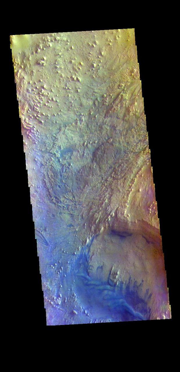 The THEMIS VIS camera contains 5 filters. The data from different filters can be combined in multiple ways to create a false color image. These false color images may reveal subtle variations of the surface not easily identified in a single band image. Today's false color image shows part of the floor of Firsoff Crater. Located in southern Arabia Terra, Firsoff Crater, and the neighboring Crommelin Crater, have large layered deposits on the crater floor. The circular feature at the bottom of the image is a smaller crater within Firsoff Crater. The layering of the interior deposit can be seen in the northern side of this smaller crater. Wind action has modified the large deposit. In this color combination dark blue typically indicates basaltic sand. Firsoff Crater is 90 km (56 miles) in diameter.  The THEMIS VIS camera is capable of capturing color images of the Martian surface using five different color filters. In this mode of operation, the spatial resolution and coverage of the image must be reduced to accommodate the additional data volume produced from using multiple filters. To make a color image, three of the five filter images (each in grayscale) are selected. Each is contrast enhanced and then converted to a red, green, or blue intensity image. These three images are then combined to produce a full color, single image. Because the THEMIS color filters don't span the full range of colors seen by the human eye, a color THEMIS image does not represent true color. Also, because each single-filter image is contrast enhanced before inclusion in the three-color image, the apparent color variation of the scene is exaggerated. Nevertheless, the color variation that does appear is representative of some change in color, however subtle, in the actual scene. Note that the long edges of THEMIS color images typically contain color artifacts that do not represent surface variation.  Orbit Number: 94812 Latitude: 2.77617 Longitude: 350.268 Instrument: VIS Captured: 2023-04-30 02:58  https://photojournal.jpl.nasa.gov/catalog/PIA26134