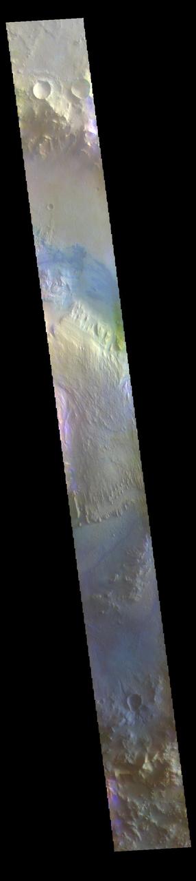 The THEMIS VIS camera contains 5 filters. The data from different filters can be combined in multiple ways to create a false color image. These false color images may reveal subtle variations of the surface not easily identified in a single band image. Today's false color image shows Gale Crater. Gale Crater is the home of the Curiosity Rover. Gale Crater is 154 km (95 miles) in diameter. The THEMIS VIS camera is capable of capturing color images of the Martian surface using five different color filters. In this mode of operation, the spatial resolution and coverage of the image must be reduced to accommodate the additional data volume produced from using multiple filters. To make a color image, three of the five filter images (each in grayscale) are selected. Each is contrast enhanced and then converted to a red, green, or blue intensity image. These three images are then combined to produce a full color, single image. Because the THEMIS color filters don't span the full range of colors seen by the human eye, a color THEMIS image does not represent true color. Also, because each single-filter image is contrast enhanced before inclusion in the three-color image, the apparent color variation of the scene is exaggerated. Nevertheless, the color variation that does appear is representative of some change in color, however subtle, in the actual scene. Note that the long edges of THEMIS color images typically contain color artifacts that do not represent surface variation. Orbit Number: 95044 Latitude: -5.28468 Longitude: 138.309 Instrument: VIS Captured: 2023-05-19 05:23 https://photojournal.jpl.nasa.gov/catalog/PIA26139