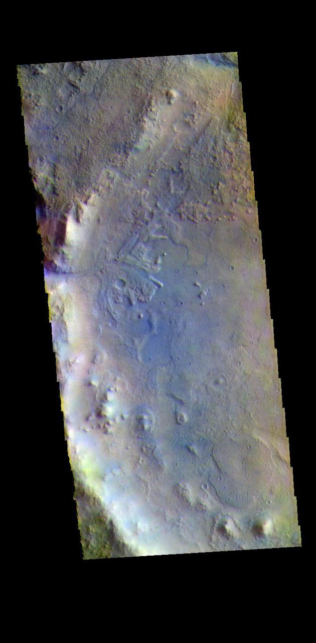 The THEMIS VIS camera contains 5 filters. The data from different filters can be combined in multiple ways to create a false color image. These false color images may reveal subtle variations of the surface not easily identified in a single band image. Today's false color image shows the western half of Jezero Crater. The Perserverance Rover is located in this part of the crater – near the delta deposit formed by the influx of silt laden water into the crater at a time during Mars' past that was wetter. The crater most likely hosted a lake for a period of time. Jezero Crater is 47km (29 miles) in diameter.  The THEMIS VIS camera is capable of capturing color images of the Martian surface using five different color filters. In this mode of operation, the spatial resolution and coverage of the image must be reduced to accommodate the additional data volume produced from using multiple filters. To make a color image, three of the five filter images (each in grayscale) are selected. Each is contrast enhanced and then converted to a red, green, or blue intensity image. These three images are then combined to produce a full color, single image. Because the THEMIS color filters don't span the full range of colors seen by the human eye, a color THEMIS image does not represent true color. Also, because each single-filter image is contrast enhanced before inclusion in the three-color image, the apparent color variation of the scene is exaggerated. Nevertheless, the color variation that does appear is representative of some change in color, however subtle, in the actual scene. Note that the long edges of THEMIS color images typically contain color artifacts that do not represent surface variation.  Orbit Number: 95046 Latitude: 18.449 Longitude: 77.436 Instrument: VIS Captured: 2023-05-19 09:28  https://photojournal.jpl.nasa.gov/catalog/PIA26140
