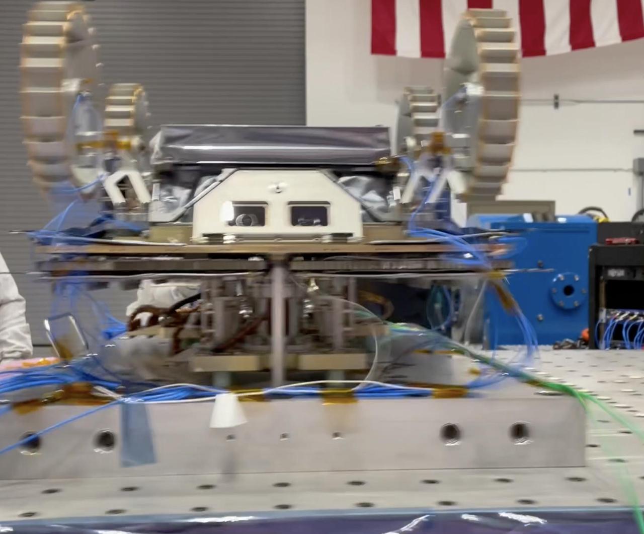 A small Moon-bound rover is clamped to a special "shaker table" that vibrates intensely to make sure the hardware will survive the jarring rocket ride out of Earth's atmosphere. This is one of three rovers – each about the size of a carry-on suitcase – that are part of NASA's CADRE (Cooperative Autonomous Distributed Robotic Exploration) technology demonstration. This vibration testing took place in November 2023 at a National Technical Systems test facility in Santa Clarita, California. In the video, the rover is shaken in two directions – first along the "z" axis and then the "x" axis. Another test, not shown, subjected the rover to a "y" axis vibration test. CADRE is designed to show that a group of robotic spacecraft can work together as a team to accomplish tasks and record data autonomously &ndash without explicit commands from mission controllers on Earth. The three small rovers will ride aboard a lunar lander that will carry the project's base station and camera assembly. Video available at https://photojournal.jpl.nasa.gov/catalog/PIA26167