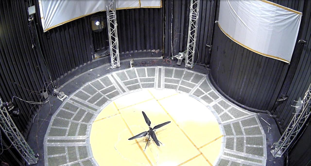 This image shows a test flight of a full-scale prototype of the Ingenuity Mars Helicopter. The flight took place on May 31, 2016, in the 25-foot-wide, 85-foot-tall (8-meter-by-26-meter) Space Simulator Facility at NASA's Jet Propulsion Laboratory in Southern California. The flight was the first demonstration that powered-controlled flight could be successfully executed in Mars-like conditions.  The simulator's vacuum chamber allows engineers to test spacecraft and components in conditions like those they would face on Mars.  https://photojournal.jpl.nasa.gov/catalog/PIA26233
