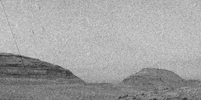 NASA's Curiosity Mars rover captured evidence of a solar storm's charged particles arriving at the Martian surface in this three-frame video taken by one of the rover's navigation cameras on May 20, 2024, the 4,190th Martian day, or sol, of the mission.  The mission regularly captures videos to try and catch dust devils, or dust-bearing whirlwinds. While none were spotted in this particular sequence of images, engineers did see streaks and specks – visual artifacts created when charged particles from the Sun hit the camera's image detector. The particles do not damage the detector.  The images in this sequence appear grainy because navigation-camera images are processed to highlight changes in the landscape from frame to frame. When there isn't much change – in this case, the rover was parked &ndash more noise appears in the image.  Curiosity's Radiation Assessment Detector (RAD) measured a sharp increase in radiation at this time – the biggest radiation surge the mission has seen since landing in 2012.  Animation available at https://photojournal.jpl.nasa.gov/catalog/PIA26302