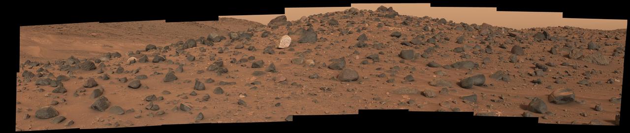 Composed of 18 images, this natural-color mosaic shows a boulder field on "Mount Washburn" (named after a mountain in Wyoming) in Mars' Jezero Crater. The Perseverance science team nicknamed the light-toned boulder with dark speckles near the center of the mosaic "Atoko Point" (after a feature in the eastern Grand Canyon). The images were acquired by NASA's Perseverance Mars rover on May 27, 2024, the 1,162nd Martian day, or sol, of the mission.  Analysis by the rover's SuperCam and Mastcam-Z instruments indicate Atoko Point is composed of the mineral pyroxene, similar to some boulders the rover has encountered elsewhere in Jezero Crater. In terms of the size, shape, and arrangement of its mineral grains and crystals – and potentially its chemical composition – Atoko Point is different from any of the rocks the rover has encountered before.  Some Perseverance scientists speculate the minerals that make up Atoko Point were produced in a subsurface body of magma that is possibly exposed now on the crater rim. Others on the team wonder if the boulder, which stands about 18 inches (45 centimeters) wide and 14 inches (35 centimeters) tall, had been created far beyond the walls of Jezero and transported there by swift Martian waters eons ago.  Arizona State University leads the operations of the Mastcam-Z instrument, working in collaboration with Malin Space Science Systems in San Diego, on the design, fabrication, testing, and operation of the cameras, and in collaboration with the Niels Bohr Institute of the University of Copenhagen on the design, fabrication, and testing of the calibration targets.  A key objective for Perseverance's mission on Mars is astrobiology, including the search for signs of ancient microbial life. The rover will characterize the planet's geology and past climate, pave the way for human exploration of the Red Planet, and be the first mission to collect and cache Martian rock and regolith (broken rock and dust).  Subsequent NASA missions, in cooperation with ESA (European Space Agency), would send spacecraft to Mars to collect these sealed samples from the surface and return them to Earth for in-depth analysis.  The Mars 2020 Perseverance mission is part of NASA's Moon to Mars exploration approach, which includes Artemis missions to the Moon that will help prepare for human exploration of the Red Planet.  https://photojournal.jpl.nasa.gov/catalog/PIA26333