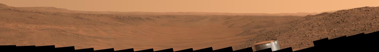 Stitched together from 56 images from NASA's Perseverance Mars rover, this natural-color mosaic looks downstream of the Neretva Vallis river channel, which fed Jezero Crater with fresh water billions of years ago. The rover captured the images with its Mastcam-Z camera on May 17, 2024, the 1152nd Martian day, or sol, of the mission.  "Mount Washburn" is to the far left (north is to the left; southeast is to the right), about 660 feet (200 meters) away. Approximately quarter-mile (400 meters) wide with sand dunes and ripples, Neretva Vallis is at the center of the image. Prior to entering the channel, Perseverance had driven for several months along a boulder-filled route just beyond the camera view on the right of this mosaic. Perseverance's ultra-high-frequency antenna is visible right of center in the foreground.  Arizona State University leads the operations of the Mastcam-Z instrument, working in collaboration with Malin Space Science Systems in San Diego, on the design, fabrication, testing, and operation of the cameras, and in collaboration with the Niels Bohr Institute of the University of Copenhagen on the design, fabrication, and testing of the calibration targets.  A key objective for Perseverance's mission on Mars is astrobiology, including the search for signs of ancient microbial life. The rover will characterize the planet's geology and past climate, pave the way for human exploration of the Red Planet, and be the first mission to collect and cache Martian rock and regolith (broken rock and dust).  Subsequent NASA missions, in cooperation with ESA (European Space Agency), would send spacecraft to Mars to collect these sealed samples from the surface and return them to Earth for in-depth analysis.  The Mars 2020 Perseverance mission is part of NASA's Moon to Mars exploration approach, which includes Artemis missions to the Moon that will help prepare for human exploration of the Red Planet.  https://photojournal.jpl.nasa.gov/catalog/PIA26335