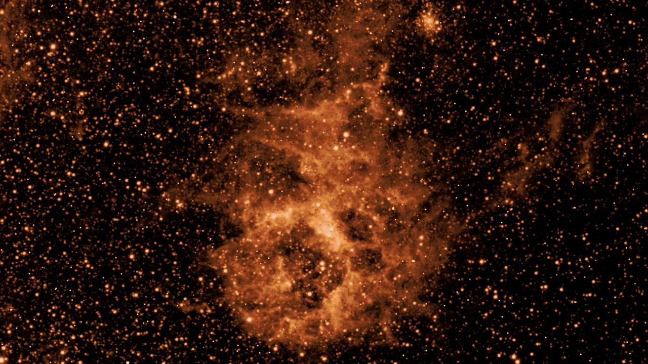 In April 2025, just weeks after its launch, NASA's SPHEREx mission revealed a cloud of dust in a patch of sky inside the Large Magellanic Cloud, a dwarf galaxy near the Milky Way, when making observations in a specific infrared wavelength (3.29 microns).  The difference between the images illustrates the power of multiwavelength observations for revealing hidden features of the universe – a key feature of SPHEREx.  Observing individual wavelengths of light from cosmic sources is called spectroscopy. This technique can be used to reveal the composition of objects, because chemical elements and molecules leave a unique signature in the colors they absorb and emit. Spectroscopy can also help scientists measure how far away galaxies are, making it essential for SPHEREx's goal of mapping the locations of hundreds of millions of galaxies in 3D.  SPHEREx detects infrared light, which is invisible to the human eye, but is represented here in visible colors. The observatory will map the entire sky in 102 infrared colors (or wavelengths of light) to learn more about our universe. To do this, the mission images every object in the sky 102 times, each in a different wavelength. The spacecraft will map the entire sky four times over two years.  https://photojournal.jpl.nasa.gov/catalog/PIA26352