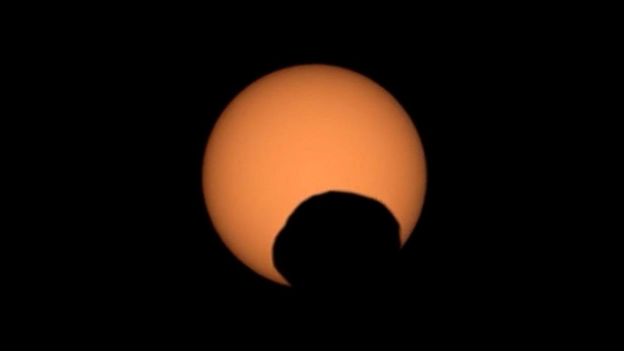 NASA's Perseverance Mars rover used its Mastcam-Z camera to capture the silhouette of Phobos, one of the two Martian moons, as it passed in front of the Sun on Sept. 30, 2024, the 1,285th Martian day, or sol, of the mission. Perseverance has captured several Phobos transits since its landing at Mars' Jezero Crater in February 2021. By comparing the various recordings, scientists can refine their understanding of the potato-shaped moon's orbit, learning how it is changing. Eons from now, Phobos' orbit is expected to eventually send the moon toward the Red Planet's surface.  Arizona State University leads the operations of the Mastcam-Z instrument, working in collaboration with Malin Space Science Systems in San Diego, on the design, fabrication, testing, and operation of the cameras, and in collaboration with the Niels Bohr Institute of the University of Copenhagen on the design, fabrication, and testing of the calibration targets.  A key objective for Perseverance's mission on Mars is astrobiology, including the search for signs of ancient microbial life. The rover will characterize the planet's geology and past climate, pave the way for human exploration of the Red Planet, and be the first mission to collect and cache Martian rock and regolith (broken rock and dust).  Subsequent NASA missions, in cooperation with ESA (European Space Agency), would send spacecraft to Mars to collect these sealed samples from the surface and return them to Earth for in-depth analysis.  The Mars 2020 Perseverance mission is part of NASA's Moon to Mars exploration approach, which includes Artemis missions to the Moon that will help prepare for human exploration of the Red Planet.  Video available at https://photojournal.jpl.nasa.gov/catalog/PIA26380 