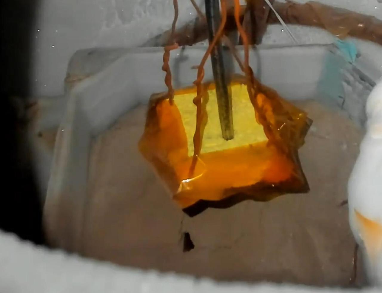 This image shows Martian soil simulant erupting in a plume during a lab experiment at NASA's Jet Propulsion Laboratory in Southern California that was designed to replicate the process believed to form Martian features called "spiders."  In the experiment, researchers chilled Martian soil simulant in a container submerged within a liquid nitrogen bath. They placed it in JPL's Dirty Under-vacuum Simulation Testbed for Icy Environments (DUSTIE), where the air pressure was reduced to be similar to that of Mars' southern hemisphere. Carbon dioxide gas flowed into the chamber – diffused through the bright yellow sponge seen suspended over the simulant here – and condensed from gas to ice over the course of three to five hours. A heater inside the chamber then warmed the simulant from below, cracking the ice. After many tries, researchers saw a plume of carbon dioxide gas erupting from within the powdery simulant, as seen here.  Video available at https://photojournal.jpl.nasa.gov/catalog/PIA26404