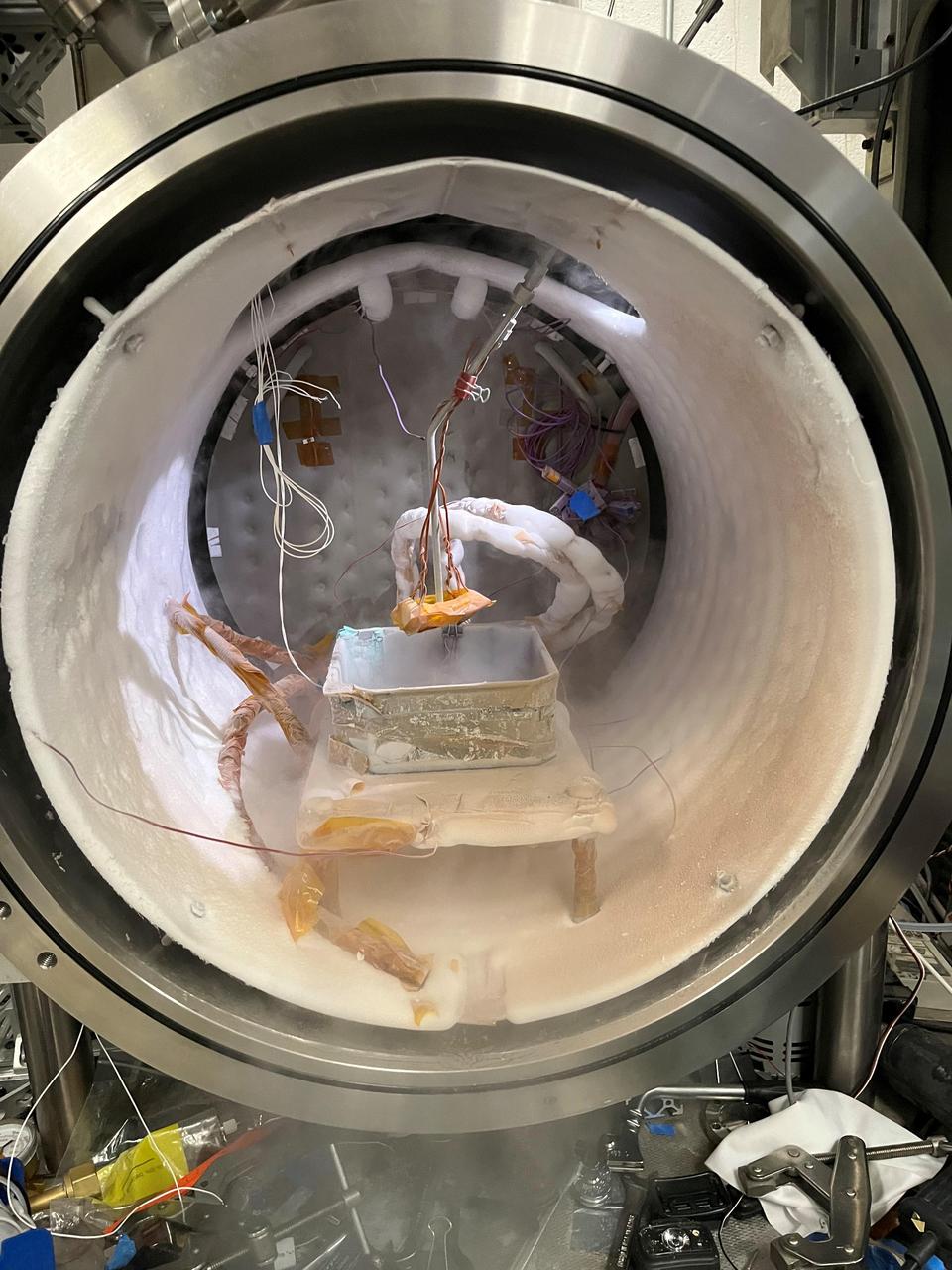 This wine barrel-size chamber at NASA's Jet Propulsion Laboratory in Southern California is used to simulate the temperatures and air pressure of other planets – in this case, the carbon dioxide ice found on the southern hemisphere of Mars. The experiment shown here simulated how Martian spider-like formations called araneiform terrain are created. Called the Dirty Under-vacuum Simulation Testbed for Icy Environments, or DUSTIE, the chamber was used to test a prototype of a rasping tool designed for NASA's Phoenix lander, which touched down on Mars' northern hemisphere in 2008. https://photojournal.jpl.nasa.gov/catalog/PIA26405