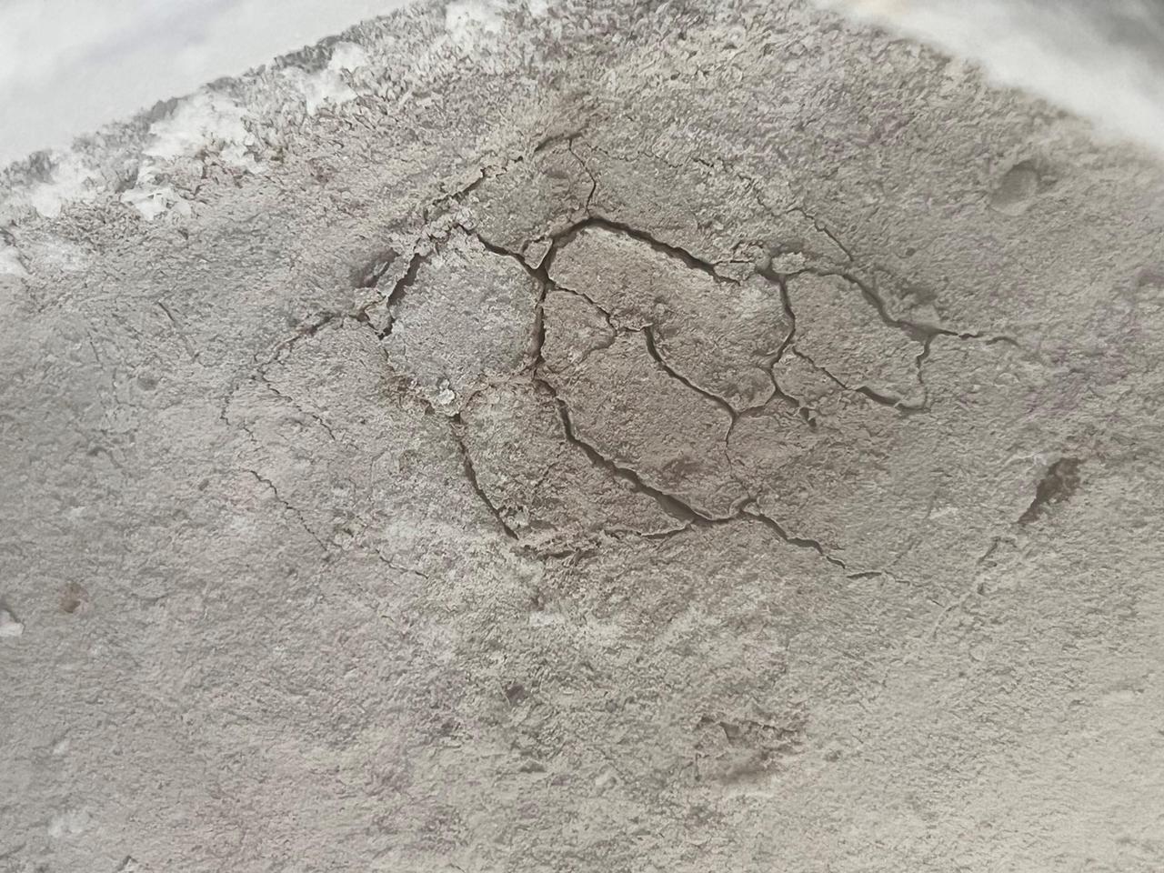       This image shows an experiment conducted at NASA's Jet Propulsion Laboratory re-creating the processes that form spider-like features on Mars called araneiform terrain. The experiment involves carbon dioxide gas settling into Mars soil simulant. The gas settles between the grains of simulant and eventually freezes into ice.      A heater underneath the soil simulant then warms up the ice and turns it back into gas. As pressure from the gas builds, the frozen top layer of simulant eventually cracks. When the pressure builds enough, a plume of carbon dioxide erupts.      The study confirms several formation processes described by what's called the Kieffer model: Sunlight heats the soil when it shines through transparent slabs of carbon dioxide ice that build up on the Martian surface each winter. Being darker than the ice above it, the soil absorbs the heat and causes the ice closest to it to turn directly into carbon dioxide gas – without turning to liquid first – in a process called sublimation (the same process that sends clouds of "smoke" billowing up from dry ice). As the gas builds in pressure, the Martian ice cracks, allowing the gas to escape.      As for what creates the spider legs, the Kieffer model suggests that as the gas vents, it carries a stream of dust and sand that scours the surface, forming scars that are revealed when the ice disappears in the spring. But the experiment also suggests an alternative explanation for the this part of the process: The researchers found that these formations could have also been created when ice formed in the pores within the soil, rather than on top of it, and that the release of gas from within this soil-ice mixture may have created the formations.      The experiment took place in JPL's Dirty Under-vacuum Simulation Testbed for Icy Environments, or DUSTIE.  https://photojournal.jpl.nasa.gov/catalog/PIA26406