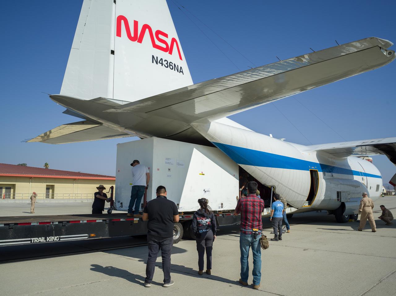 Crews at March Air Reserve Base in Riverside County, California, on Oct. 15, 2024, load a specialized shipping container carrying the NISAR (NASA ISRO Synthetic Aperture Radar) mission's radar antenna reflector into the hold of NASA's C-130 Hercules plane. The aircraft later departed on a multistage journey to Bengaluru, India, arriving on Oct. 22.  A key piece of science hardware for the mission, which is a joint effort of NASA and the Indian Space Research Organisation, the reflector had been undergoing work at a specialized facility in California. Engineers there applied reflective tape and took other precautionary measures to mitigate temperature increases that could potentially have affected the deployment of the reflector from its stowed configuration.  Drum-shaped and about 39 feet (12 meters) across, the reflector is among NASA's contributions to the mission. The reflector is designed to transmit and receive microwave signals to and from Earth's surface, enabling NISAR to scan nearly all the planet's land and ice surfaces twice every 12 days to collect science data.  Once NISAR is in operation, its observations will benefit humanity by helping researchers around the world better understand changes in the planet's surface, including its ice sheets, glaciers, and sea ice. The spacecraft will also capture changes in forest and wetland ecosystems as well as movement and deformation of our planet's crust.  https://photojournal.jpl.nasa.gov/catalog/PIA26419
