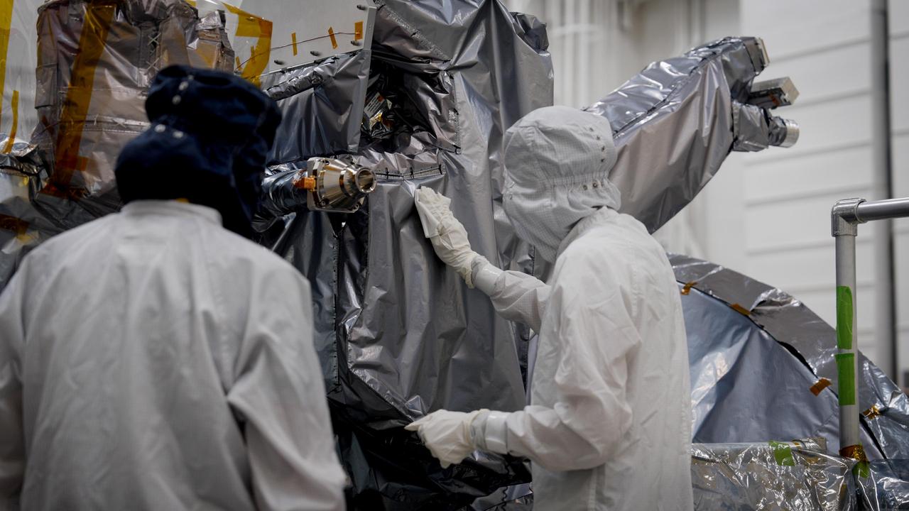 A planetary protection engineer in full-body protective gear carefully collects samples from NASA's Europa Clipper spacecraft to verify its biological cleanliness in a clean room at NASA's Jet Propulsion Laboratory on March 20, 2024.  Maintaining and verifying the cleanliness of the spacecraft helps minimize the chance that microbes brought from Earth could compromise future scientific investigations at its destination, Jupiter's moon Europa. This work, referred to as planetary protection, is conducted in keeping with the international 1967 Outer Space Treaty to explore space in a responsible manner that avoids the harmful contamination of celestial bodies. This photo was taken while Europa Clipper was being built in JPL's Spacecraft Assembly Facility.  Europa Clipper's three main science objectives are to determine the thickness of the moon's icy shell and its interactions with the ocean below, to investigate its composition, and to characterize its geology. The mission's detailed exploration of Europa will help scientists better understand the astrobiological potential for habitable worlds beyond our planet.  https://photojournal.jpl.nasa.gov/catalog/PIA26440