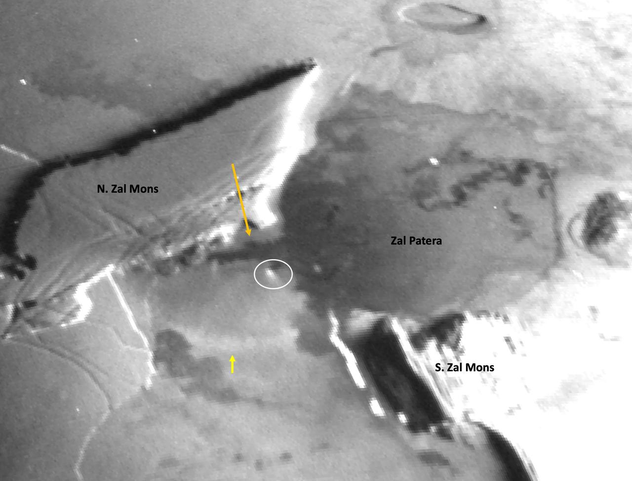 A zoom of a Dec. 30, 2023, image from the Stellar Reference Unit (SRU) aboard NASA's Juno spacecraft shows Io's night side while illuminated by Jupiter-shine. A strong stretch has been applied to highlight features observed by the SRU in the Zal Montes-Patera region, including a new 25-mile-long (41-kilometer-long) branch of fresh lava flow (indicated by the orange arrow) located to the west of Zal Patera's prior western boundary.  A new bright ring segment (indicated by the yellow arrow) is seen to the south of the new flow and may be associated with its formation. A possible low-angle jet of vaporized sulfur dioxide frost (circled in white) is observed at one of the lobed fronts of the new flow and is the first observation of a "Promethean-type jet" on Io since the original discovery at Prometheus by NASA's Galileo mission in 1999-2000.  https://photojournal.jpl.nasa.gov/catalog/PIA26490