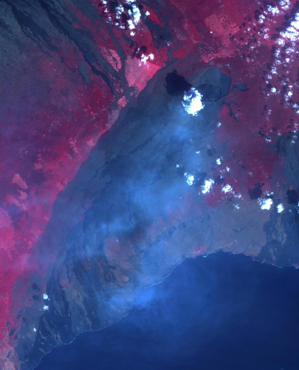 On January 18, ASTER captured this image of the continuing eruption of Kilauea volcano, Hawaii. Lava fountains in Halemaumau crater (top center of image) reached 50 m high, with a nearly vertical eruption plume. Winds carried the blue-gray plume to the south to the ocean. The TROPOMI satellite instrument detected this as a huge SO2 plume the day before. Vegetation is displayed in shades of red. The image covers an area of 38.7 by 45.8 km, and is located at 19.4 degrees north, 155.3 degrees west. https://photojournal.jpl.nasa.gov/catalog/PIA26504