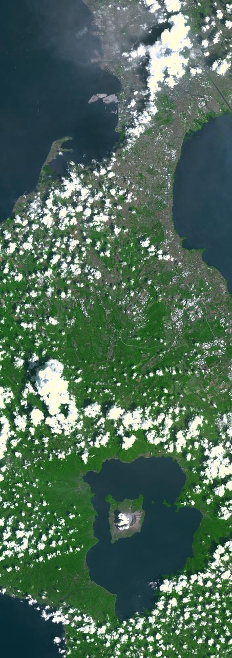 Taal Volcano in the Philippines is about 50 km south of Manila (top of image). It is the second most active volcano in the country, with 38 recorded historic eruptions. The caldera is filled by Taal Lake; Volcano Island is the active cone in the middle of the lake (bottom of image). Eruptions have occurred every year since 2019, with ash and sulfur dioxide vog at times reaching Manila. (Credit: Wikipedia) The image was acquired October 8, 2024, covers an area of 33 by 92.2 km, and is located at 14 degrees north, 121 degrees east.  https://photojournal.jpl.nasa.gov/catalog/PIA26506