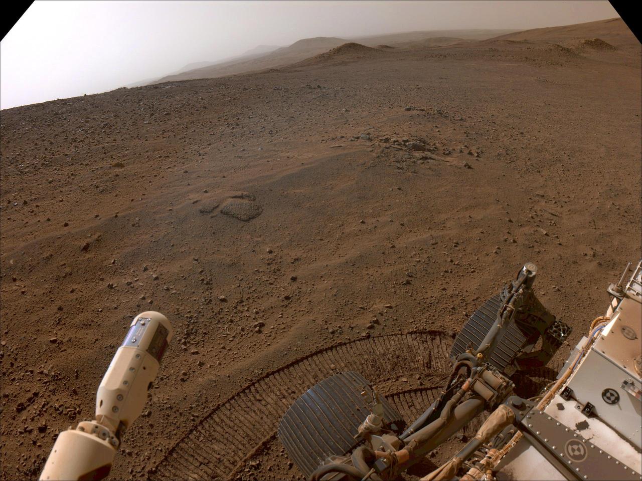 NASA's Perseverance Mars rover used its right-front navigation camera to capture this first view over the rim of Jezero Crater on Dec. 10, 2024, the 1,354th Martian day, or sol, of the mission, when it reached the end of its long climb from the crater floor.  The rover is looking west in this image from a location nicknamed "Lookout Hill." Not visible is "Witch Hazel Hill," a scientifically significant rocky outcrop that Perseverance is headed toward. Once there, the rover will spend about six months exploring the area. Scientists are excited to explore the region outside of Jezero because the rover will encounter rocks excavated by a monster meteor impact that formed the crater an estimated 3.9 billion years ago. These rocks could not only be early Martian crust, but among the oldest rocks found anywhere in the solar system.  A key objective for Perseverance's mission on Mars is astrobiology, including the search for signs of ancient microbial life. The rover will characterize the planet's geology and past climate, pave the way for human exploration of the Red Planet, and be the first mission to collect and cache Martian rock and regolith (broken rock and dust).  Subsequent NASA missions, in cooperation with ESA (European Space Agency), would send spacecraft to Mars to collect these sealed samples from the surface and return them to Earth for in-depth analysis.  The Mars 2020 Perseverance mission is part of NASA's Moon to Mars exploration approach, which includes Artemis missions to the Moon that will help prepare for human exploration of the Red Planet.  https://photojournal.jpl.nasa.gov/catalog/PIA26511
