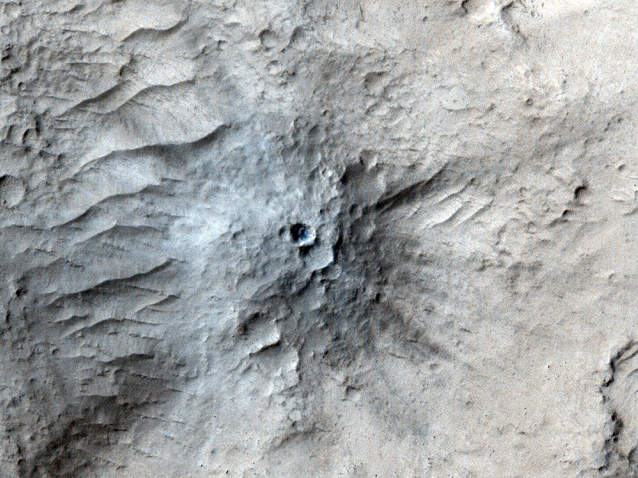 NASA's Mars Reconnaissance Orbiter used its High-Resolution Imaging Science Experiment (HiRISE) camera to capture this impact crater in Cerberus Fossae, a seismically active region of the Red Planet, on March 4, 2021. Scientists matched the crater's appearance on the surface with a quake detected by NASA's InSight lander, which was about 1,000 miles (1,640 kilometers) away. The crater is estimated to be about 71 feet (21.5 meters) in diameter. Most of the impacts detected by InSight, which was retired in 2022 after operating for more than four years, were thought to send their seismic signals through the Martian crust. But scientists concluded the energy from this impact traveled through the planet's mantle, much deeper than expected, after studying the location of the impact crater and seismic signals linked to it. Because of this finding, models of the composition and structure of the inner planet will have to be reassessed. This impact crater, along with others covered in a pair of papers published in Geophysical Research Letters in February 2025, was found with help from a machine learning algorithm developed at NASA's Jet Propulsion Laboratory in Southern California. The algorithm searched through tens of thousands of images captured by MRO's Context Camera in a matter of days, detecting 123 potential craters that may have occurred at the same time InSight was recording data. Traditional methods, in which human scientists carefully peer over images pixel by pixel, would have taken years of work to find these matches. Human scientists still had to narrow down the pool of candidate craters to 49 that matched InSight's quake data. After discovering this impact, scientists commanding MRO to take more detailed imagery with HiRISE. https://photojournal.jpl.nasa.gov/catalog/PIA26518