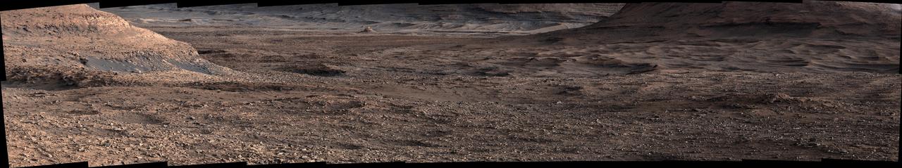NASA's Curiosity Mars rover viewed this expanse while looking out across a region filled with low ridges known as boxwork patterns. The panorama is stitched together from 23 individual images the rover's Mast Camera, or Mastcam, captured on May 22, 2025 (the 4,536th day, or sol, of the mission). The color in these images has been adjusted to match the lighting conditions as the human eye would see them on Earth. When viewed from space, the boxwork patterns look a bit like spiderwebs. They have fascinated scientists since before Curiosity's 2012 landing on the Red Planet and are believed to have formed from groundwater trickling through rock cracks billions of years ago. Minerals left behind by the water hardened like cement within the rock; after eons of sandblasting by wind, the rock was carved away, revealing networks of resistant ridges within. Curiosity's images provide the first up-close views of the boxwork region, which is located in the foothills of Mount Sharp, a 3-mile-tall (5-kilometer-tall) mountain the rover has been ascending since 2014. Video available at https://photojournal.jpl.nasa.gov/catalog/PIA26560