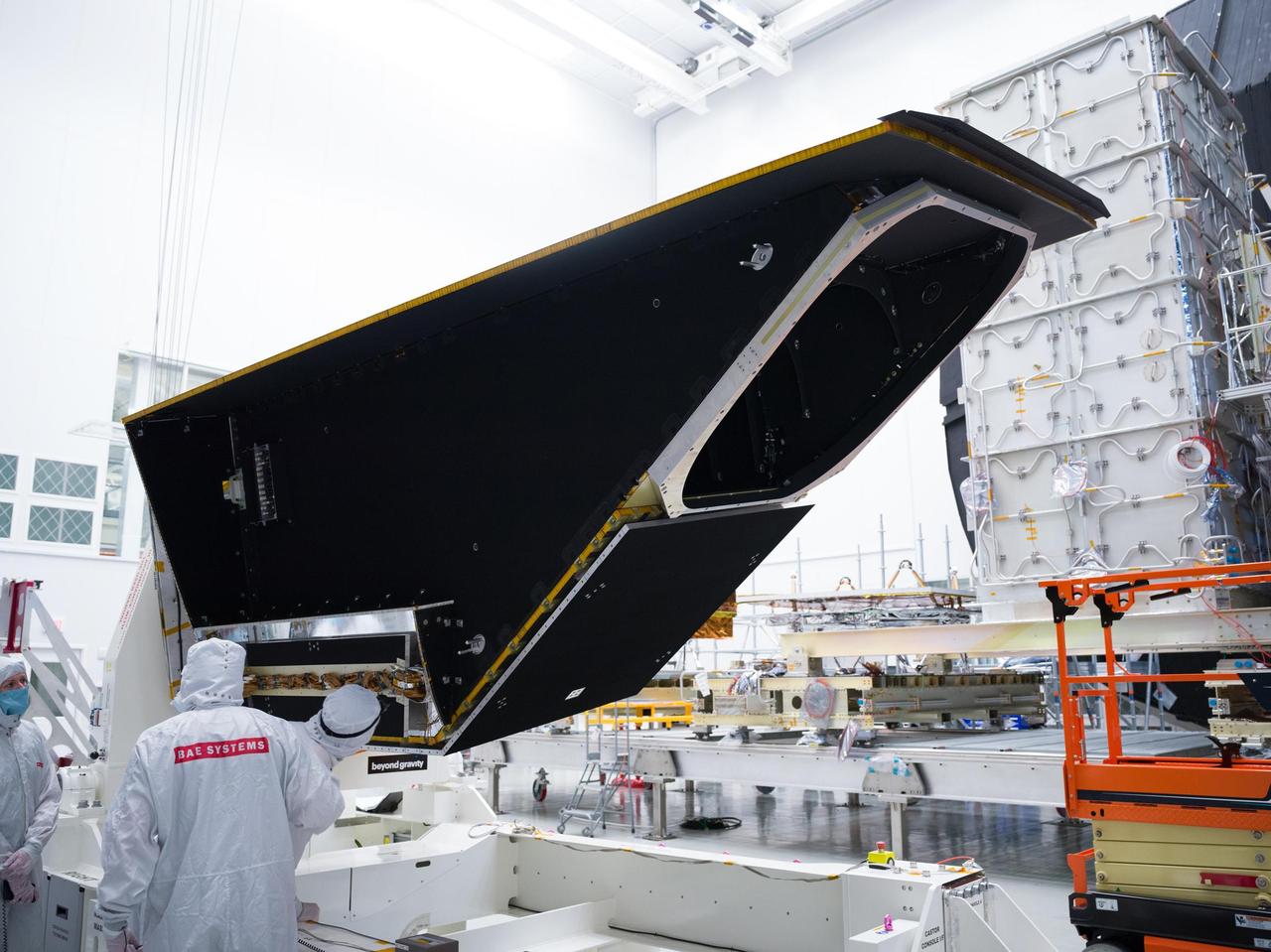 The instrument enclosure for NASA's Near-Earth Object Surveyor is prepared for environmental testing inside the historic Chamber A in the Space Environment Simulation Laboratory at the agency's Johnson Space Center in Houston in December 2024. Mounted to its articulating platform, on which it was securely positioned during assembly, the 12-foot-long (3.7-meter-long) angular structure was inspected by technicians before being placed inside the testing chamber. Figure A shows the reflective side of the instrument enclosure as it was rotated on the assembly dolly before being transferred to a testing platform. The cavernous opening to Chamber A is in the background. The instrument enclosure is designed to protect the spacecraft's infrared telescope while also removing heat from it during operations. After environmental testing was completed, the enclosure returned to NASA's Jet Propulsion Laboratory in Southern California for further work, after which it will ship to the Space Dynamics Laboratory (SDL) in Logan, Utah, and be joined to the telescope. Both the instrument enclosure and telescope were assembled at JPL. As NASA's first space-based detection mission specifically designed for planetary defense, NEO Surveyor will seek out, measure, and characterize the hardest-to-find asteroids and comets that might pose a hazard to Earth. While many near-Earth objects don't reflect much visible light, they glow brightly in infrared light due to heating by the Sun. The spacecraft's telescope, which has an aperture of nearly 20 inches (50 centimeters), features detectors sensitive to two infrared wavelengths in which near-Earth objects re-radiate solar heat. Targeting launch in late 2027, the NEO Surveyor mission is led by Prof. Amy Mainzer at UCLA for NASA's Planetary Defense Coordination Office and is being managed by JPL for the Planetary Missions Program Office at NASA's Marshall Space Flight Center in Huntsville, Alabama. BAE Systems, SDL, and Teledyne are among the companies that were contracted to build the spacecraft and its instrumentation. The Laboratory for Atmospheric and Space Physics at the University of Colorado Boulder will support operations, and Caltech/IPAC in Pasadena, California, is responsible for producing some of the mission's data products. Caltech manages JPL for NASA. https://photojournal.jpl.nasa.gov/catalog/PIA26582