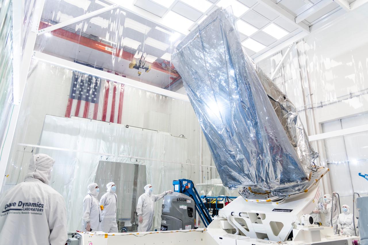 The instrument enclosure for NASA's Near-Earth Object (NEO) Surveyor on May 22, 2025, is seen in a clean room at the Space Dynamics Laboratory (SDL) in Logan, Utah, shortly after arriving from the agency's Jet Propulsion Laboratory in Southern California, where it was assembled. The instrument enclosure is attached to an articulating assembly dolly and wrapped in silver-colored material (composed of a metalized polyester film and a low charging polyethylene laminate) to protect the flight hardware from static electricity and dust particles during transport.  The instrument enclosure will house the observatory's scientific instrument, which includes a three-reflection aluminum telescope, state-of-the-art infrared detectors, and an innovative passive cooling system to keep the instrument at cryogenic temperatures.  The telescope, which has an aperture of nearly 20 inches (50 centimeters), features detectors sensitive to two infrared wavelengths in which near-Earth objects re-radiate solar heat. The instrument enclosure is designed to ensure heat produced by the spacecraft and instrument during operations doesn't interfere with its infrared observations.  As NASA's first space-based detection mission specifically designed for planetary defense, NEO Surveyor will seek out, measure, and characterize the hardest-to-find asteroids and comets that might pose a hazard to Earth. While many near-Earth objects don't reflect much visible light, they glow brightly in infrared light due to heating by the Sun.  Targeting launch in late 2027, the NEO Surveyor mission is led by Professor Amy Mainzer at UCLA for NASA's Planetary Defense Coordination Office and is being managed by JPL for the Planetary Missions Program Office at NASA's Marshall Space Flight Center in Huntsville, Alabama. BAE Systems, SDL, and are among the companies that were contracted to build the spacecraft and its instrumentation. The Laboratory for Atmospheric and Space Physics at the University of Colorado Boulder will support operations, and IPAC at Caltech in Pasadena, California, is responsible for producing some of the mission's data products. Caltech manages JPL for NASA.  https://photojournal.jpl.nasa.gov/catalog/PIA26589