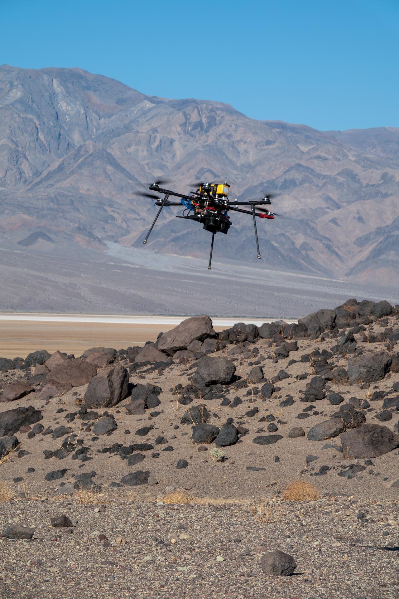 One of three drones used in recent tests by NASA’s Jet Propulsion Laboratory in Southern California flies over Mars Hill, a region of Death Valley National Park, in September 2025. The region’s rubbly, volcanic rocks have served as a Mars-like testing area and analog site for scientists since the 1970s, when NASA was preparing to land the twin Viking spacecraft on the Red Planet.  The drone research — tests of navigation software for the Martian surface — was one of 25 projects funded by NASA’s Mars Exploration Program this past year to push the limits of future technologies. Sand dunes confused the navigation algorithm of the Ingenuity Mars helicopter during several of its last flights, including its 72nd and final flight on the Red Planet in January 2024. The navigation software in development would help future rotorcraft to track the surface of especially bland, featureless terrain similar to the barren sand dunes seen in parts of Death Valley and in the Mojave Desert and to land safely in cluttered environments like Mars Hill. 