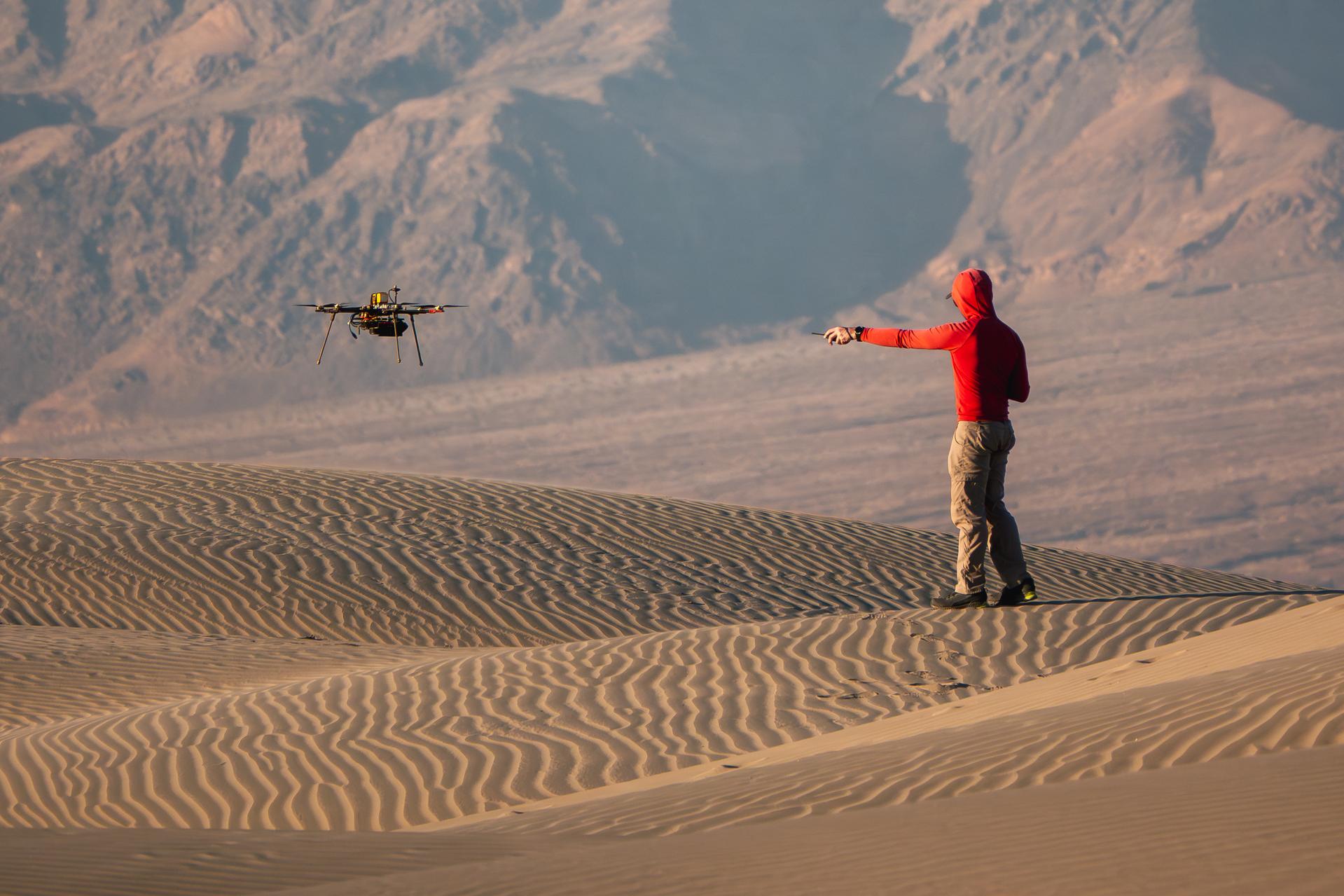A researcher from NASA’s Jet Propulsion Laboratory in Southern California monitors a drone as it flies over sand dunes in September 2025. This image was captured in Death Valley National Park during a larger test campaign to develop navigation software that would guide future rotorcraft on Mars. The work was among 25 projects funded by NASA’s Mars Exploration Program this past year to push the limits of future technologies. Sand dunes confused the navigation algorithm of the Ingenuity Mars helicopter during several of its last flights, including its 72nd and final flight on the Red Planet in January 2024. The navigation software in development would help future rotorcraft track the surface of especially bland, featureless terrain similar to the barren sand dunes seen in parts of Death Valley. Tests also included flights over a region of the park called Mars Hill, which is littered with rubbly volcanic rocks and has been used by NASA’s Mars researchers since the 1970s, during preparations for the Viking lander missions.