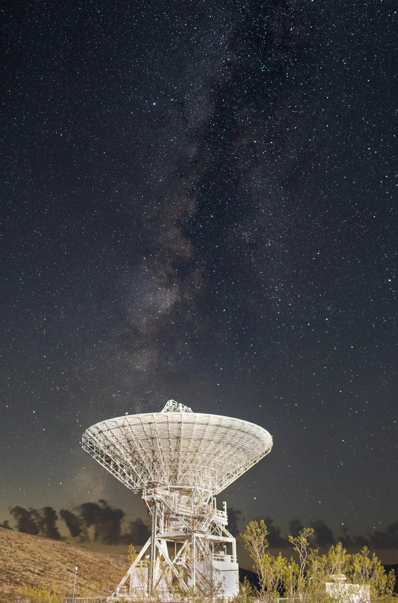 Deep Space Station 15 (DSS-15), one of the 112-foot (34-meter) antennas at the Goldstone Deep Space Communications Complex near Barstow, California, looks skyward, with the stars of the Milky Way overhead, in September 2025. Goldstone is part of NASA’s Deep Space Network (DSN), which operates three complexes around the globe that support communications with dozens of deep space missions. For more information about the DSN, visit: https://www.nasa.gov/communicating-with-missions/dsn/