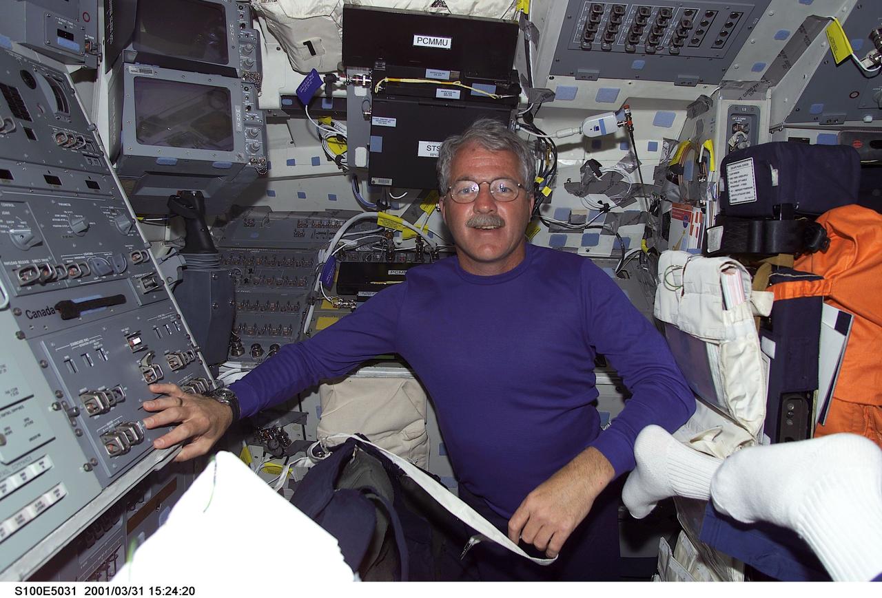 S100-E-5031 (20 April 2001)--- Astronaut John L. Phillips, mission specialist for STS-100, is pictured on the aft flight deck of the Space Shuttle Endeavour as the shuttle steadily makes its way toward the International Space Station (ISS) following an April 19 launch.  This image was recorded by a fellow crew member using a digital still camera.