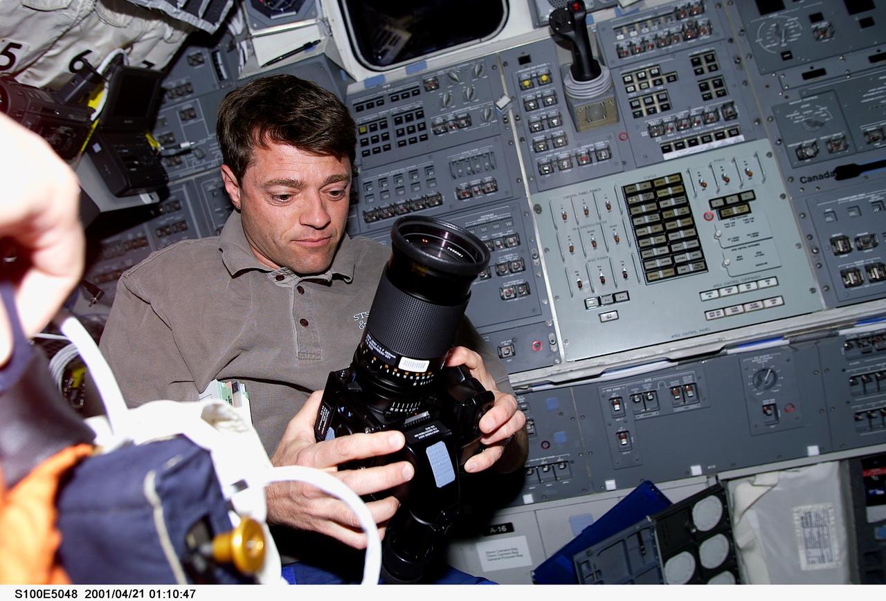 S100-E-5048 (21 April 2001) --- Astronaut Jeffrey S. Ashby, pilot, prepares to use a camera for out-the-window imagery from the aft flight deck of the Earth-orbiting Space Shuttle Endeavour. The seven-member STS-100 crew is moving toward a rendezvous with the International Space Station (ISS). The image was recorded with a digital still camera