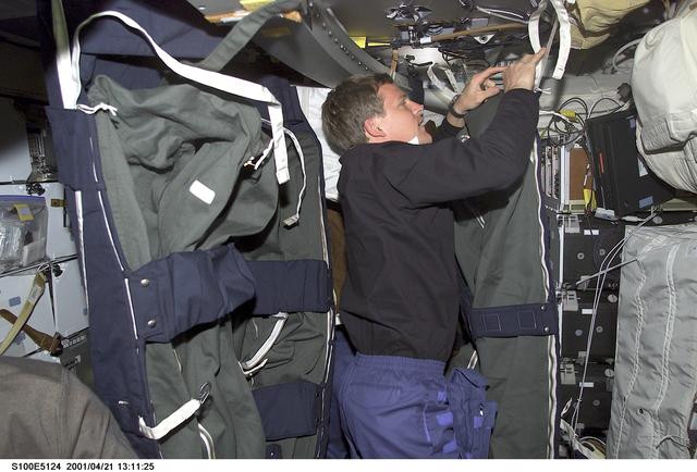 NASA image: MS Parazynski looks through a stowage bag on the middeck of Endeavour